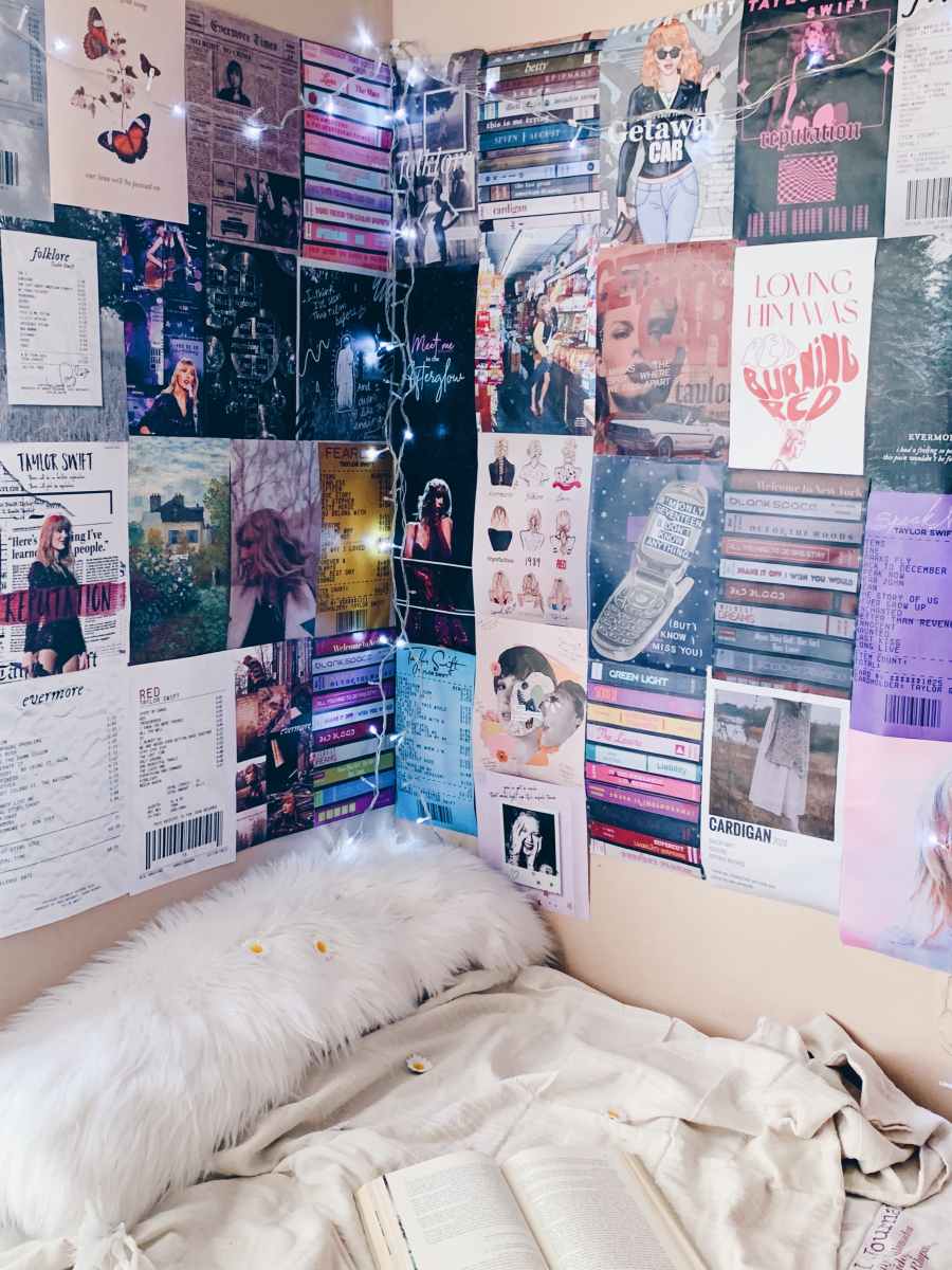 A bedroom with books and posters on the wall - Taylor Swift