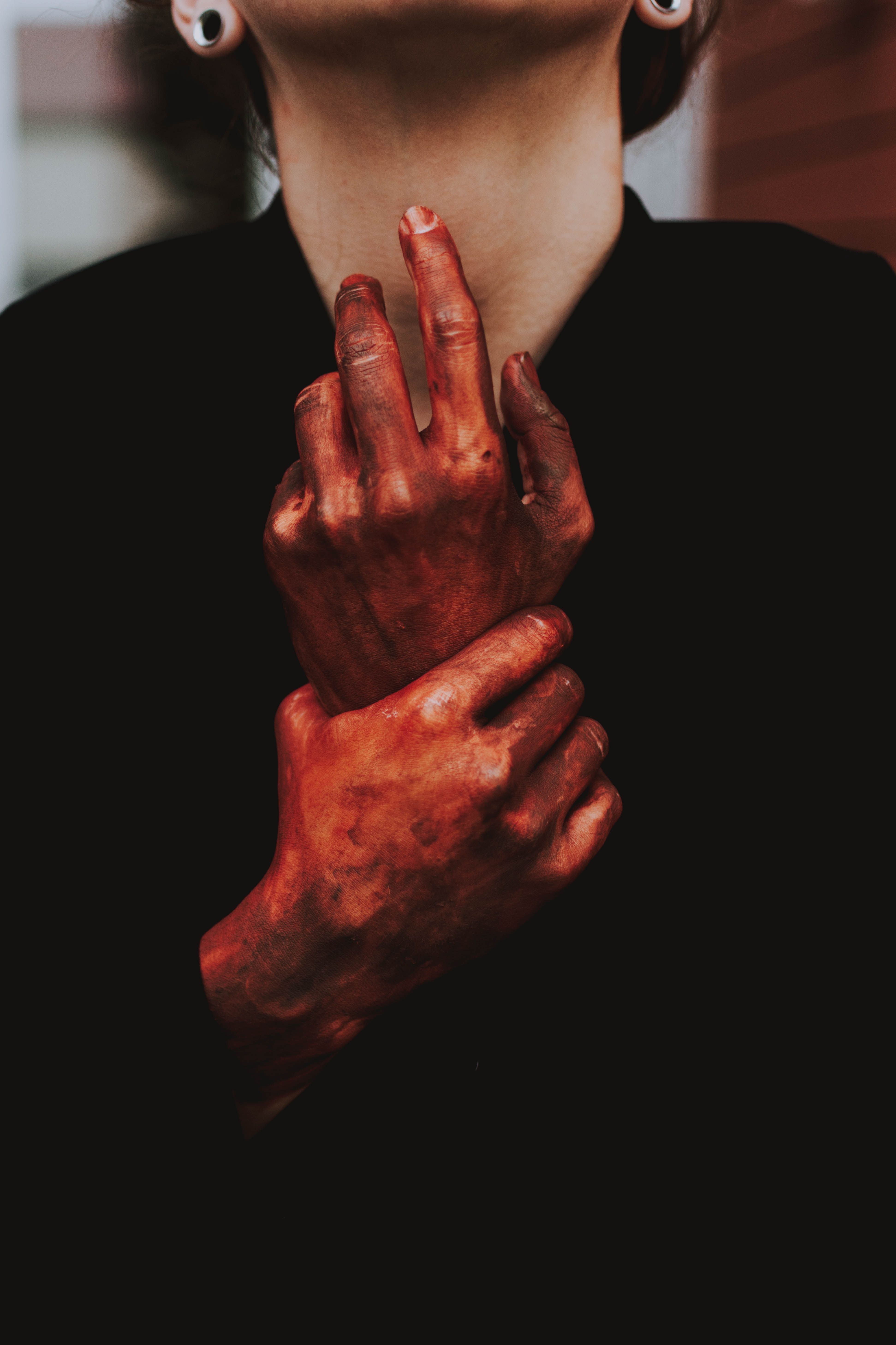 A woman with red paint on her hands - Blood