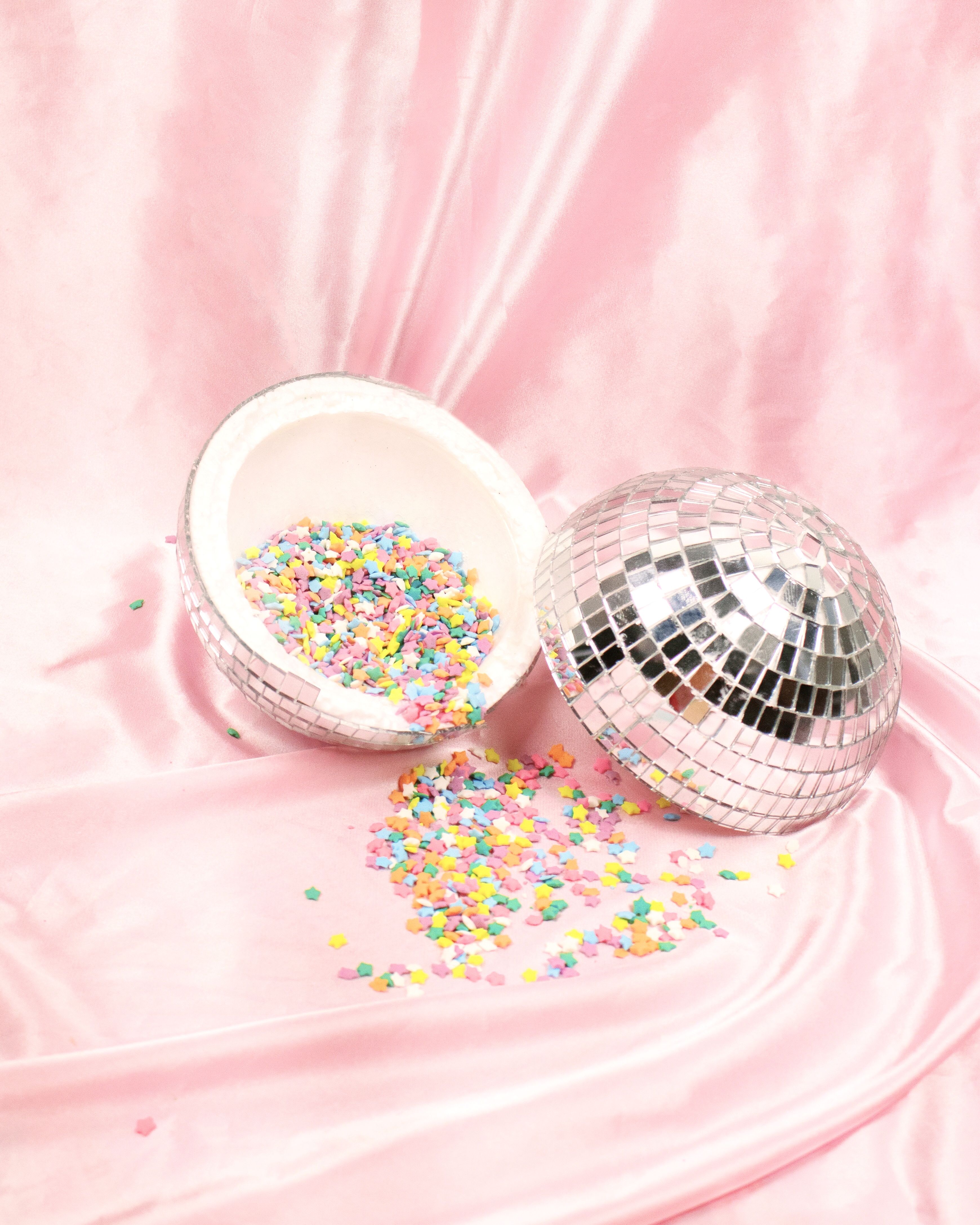 A silver disco ball with sprinkles on it - Birthday, candy