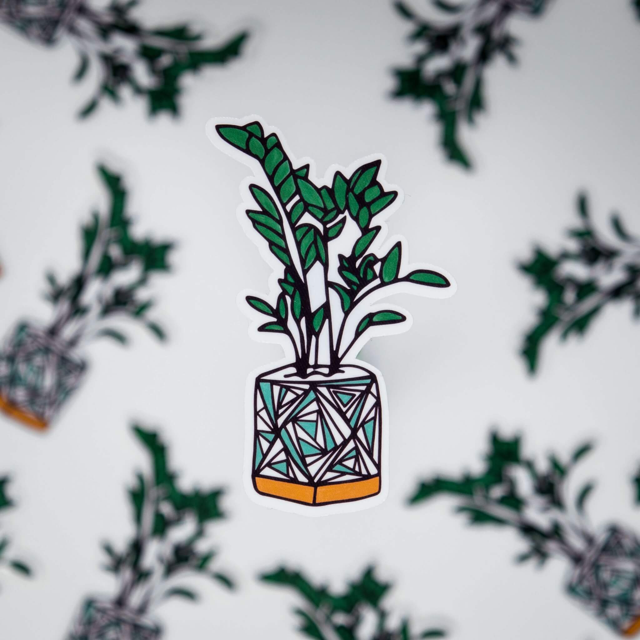 A sticker of a potted plant with a white base and an orange pot. The plant has long, spindly green leaves that are jagged and pointy. The background is a white field with other copies of the plant in the background. - Succulent, sticker