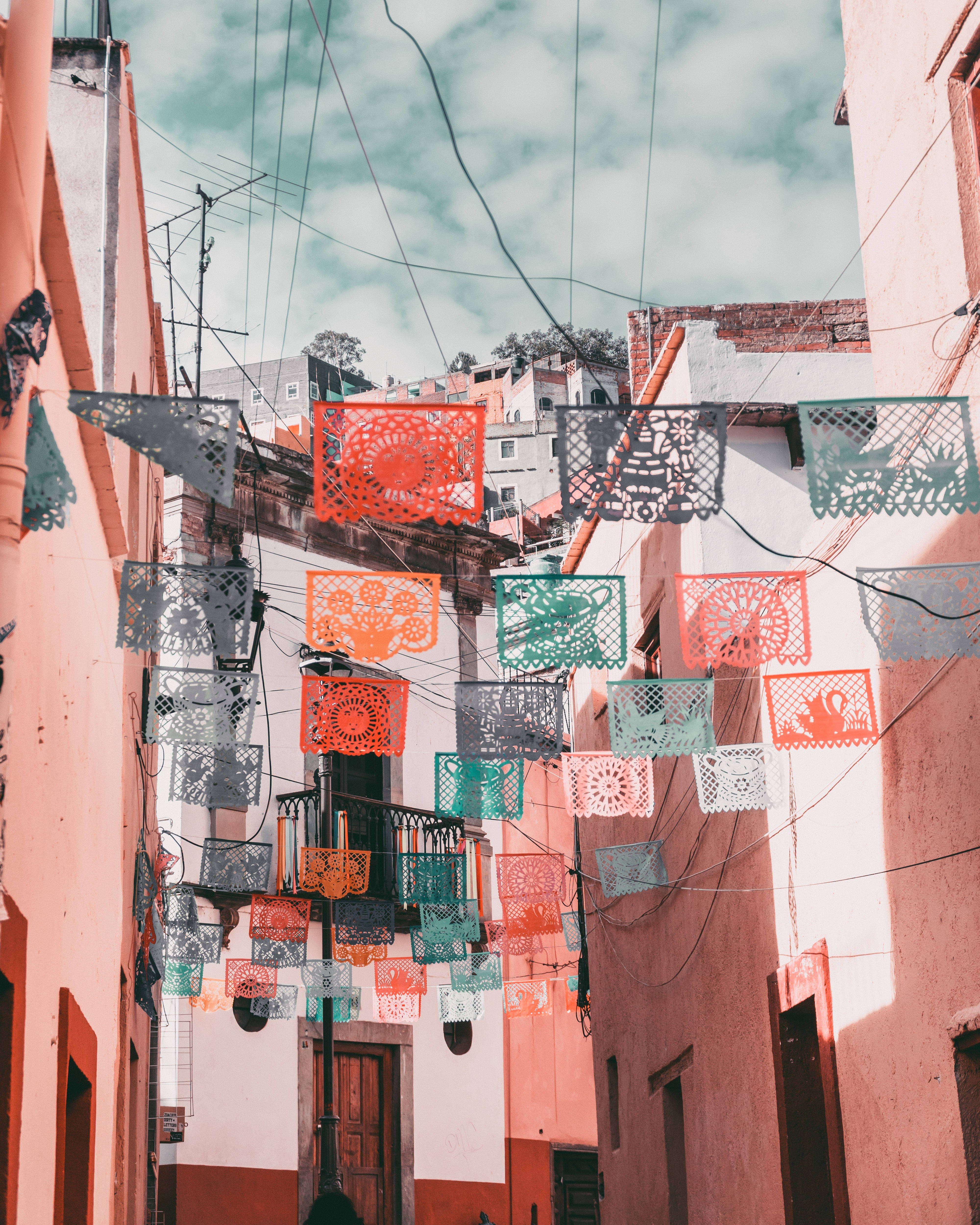 A street with buildings and colorful flags - Mexico