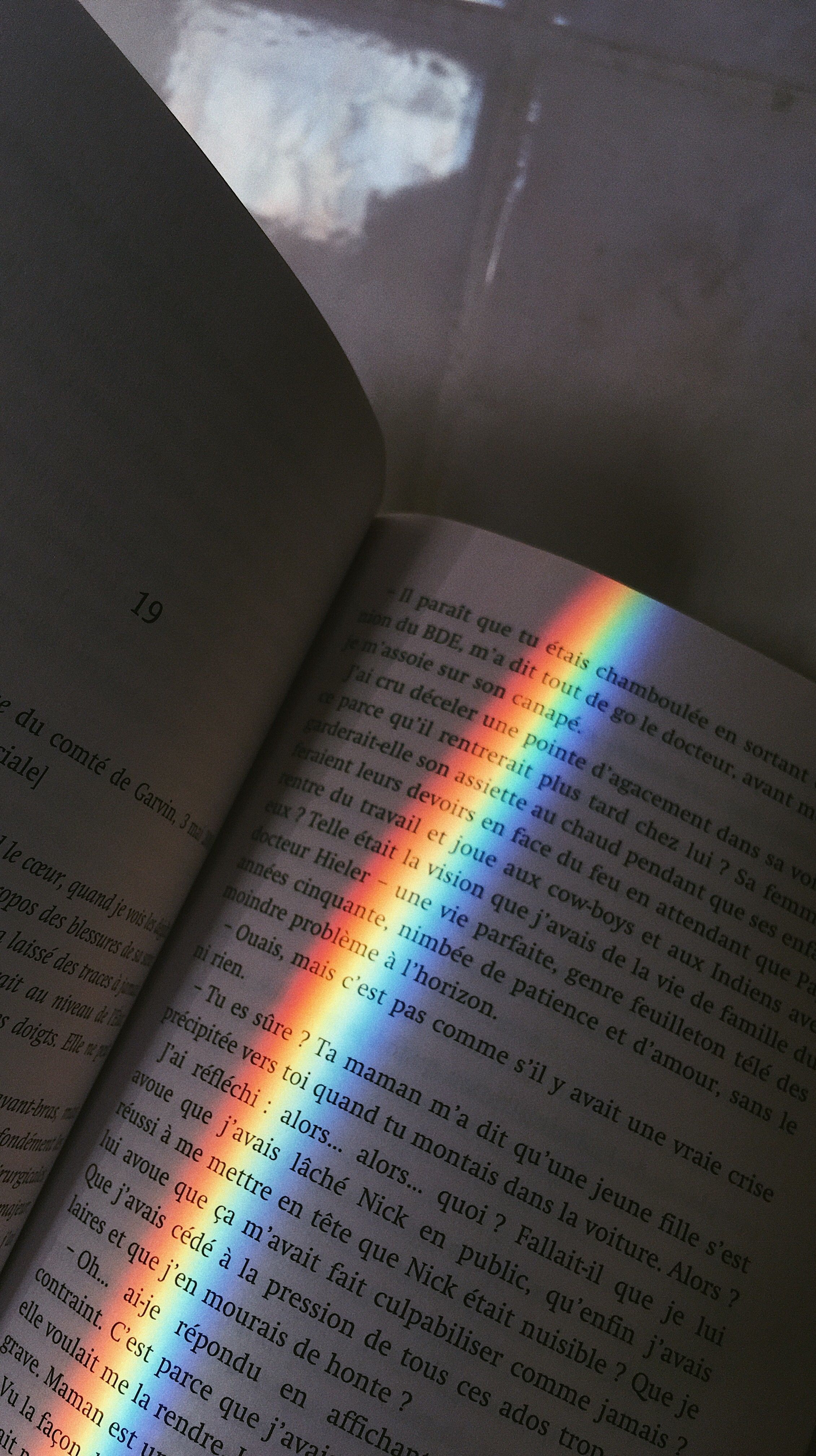 A book is open to the page with rainbow - Rainbows