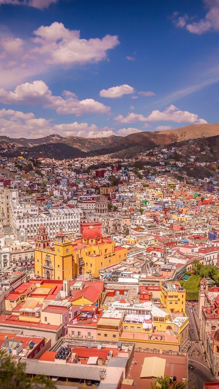 A city with many colorful buildings and mountains - Mexico