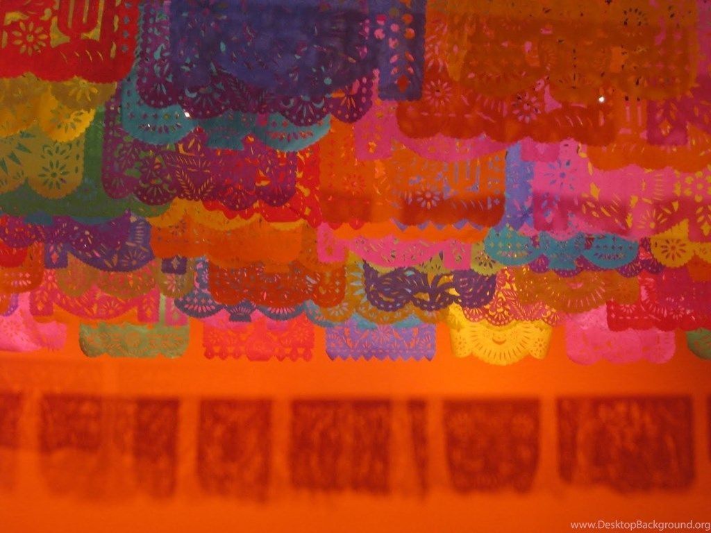 A colorful papel picado decoration hanging from the ceiling. - Mexico