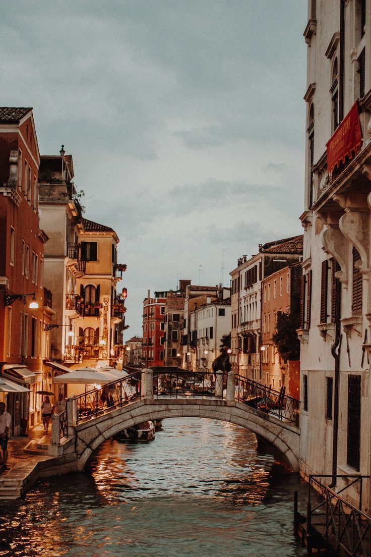 A canal with buildings on either side - Italy