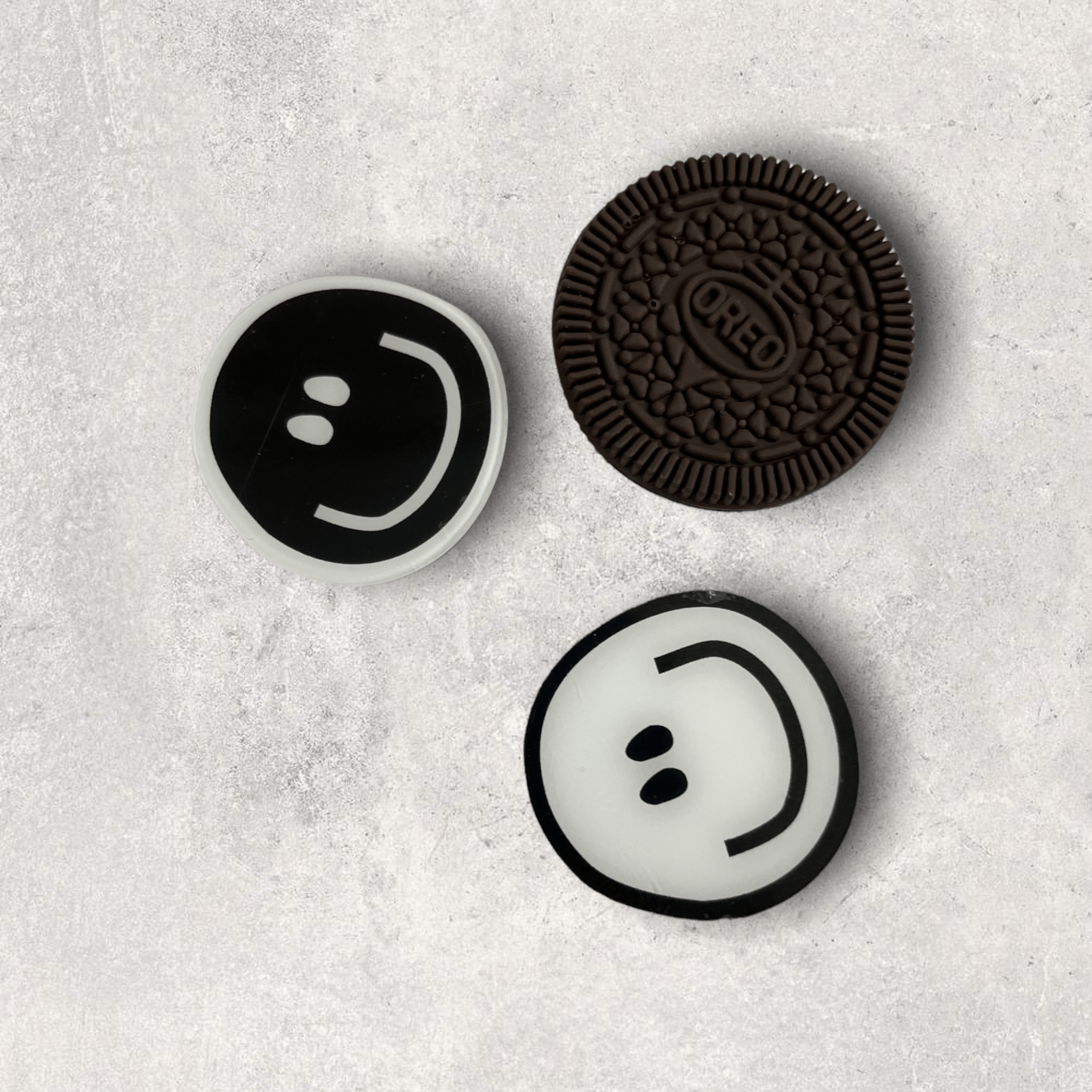 A cookie with a smiley face on it - Oreo