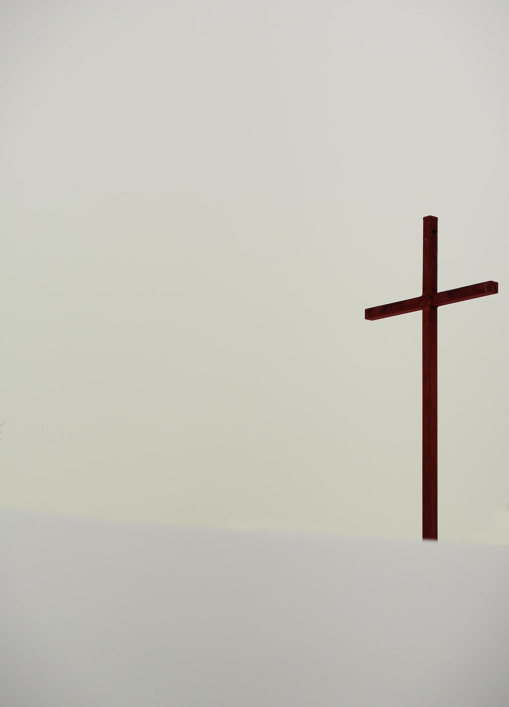 A wooden cross on a white background. - Cross