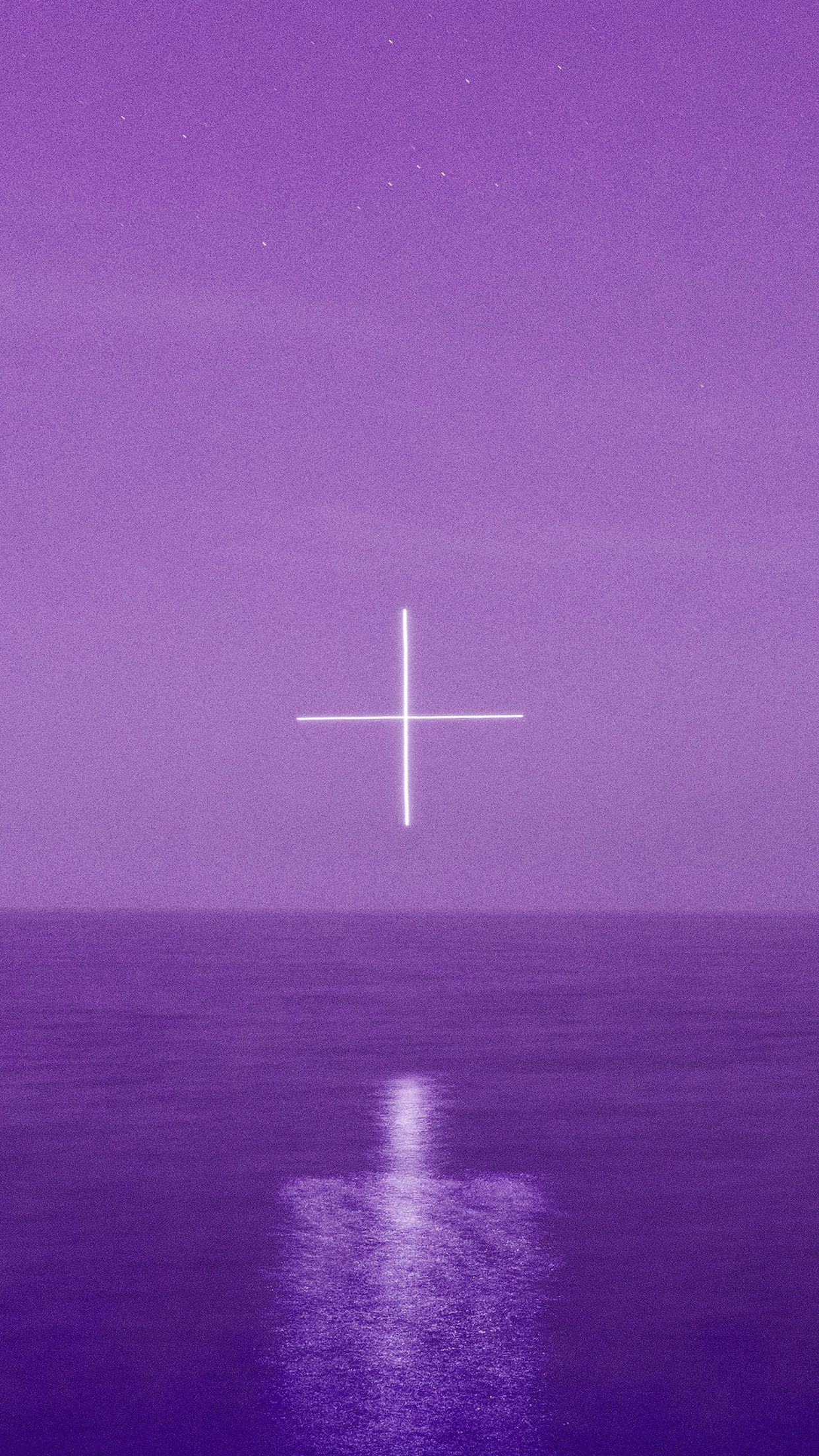 A cross is in the sky over water - Cross