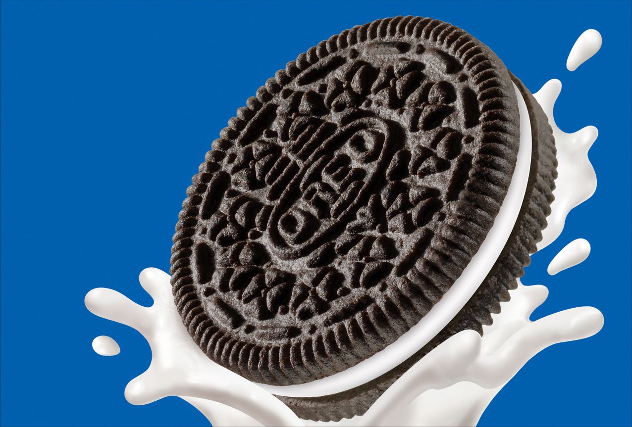 A cookie is falling into milk - Oreo