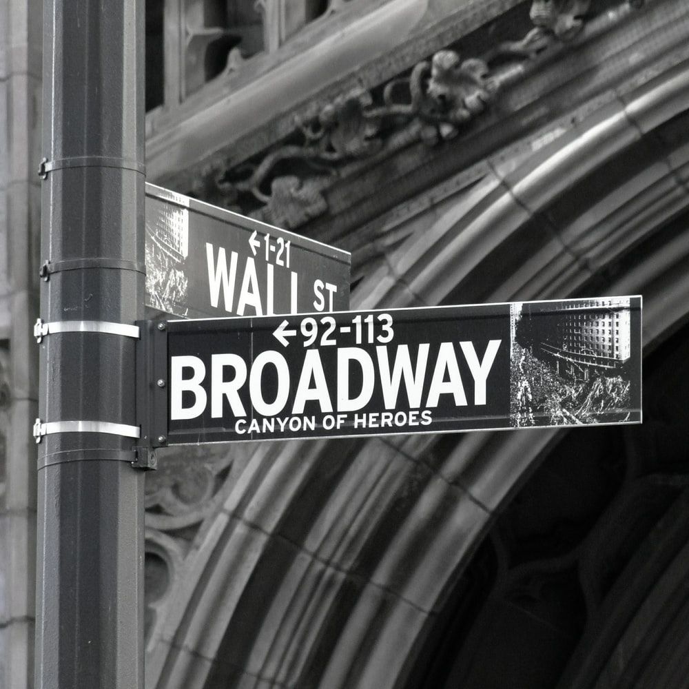 A street sign for Broadway is shown in black and white. - Broadway