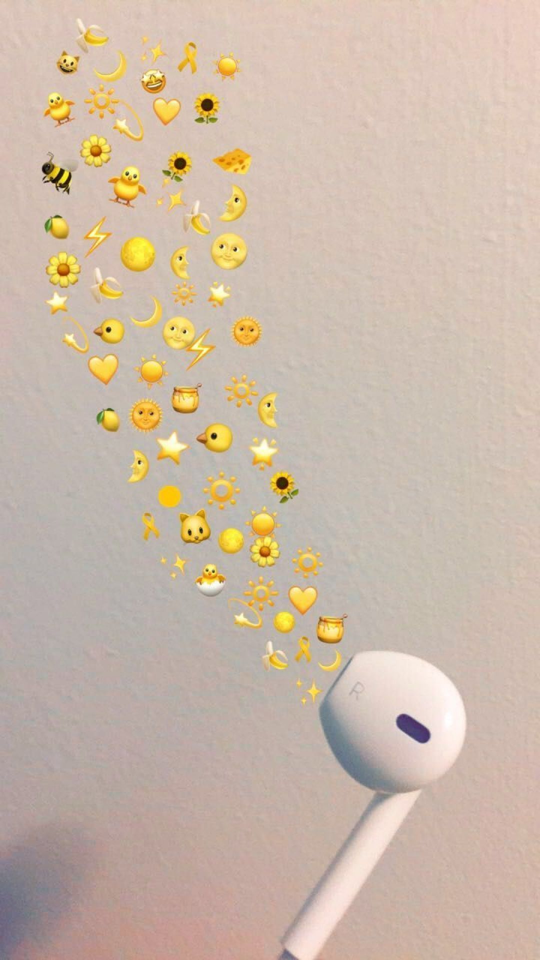 A picture of a white earphone with emojis flying out of it - Emoji