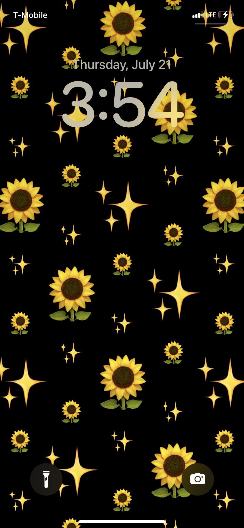 A black phone screen with yellow flowers - Emoji