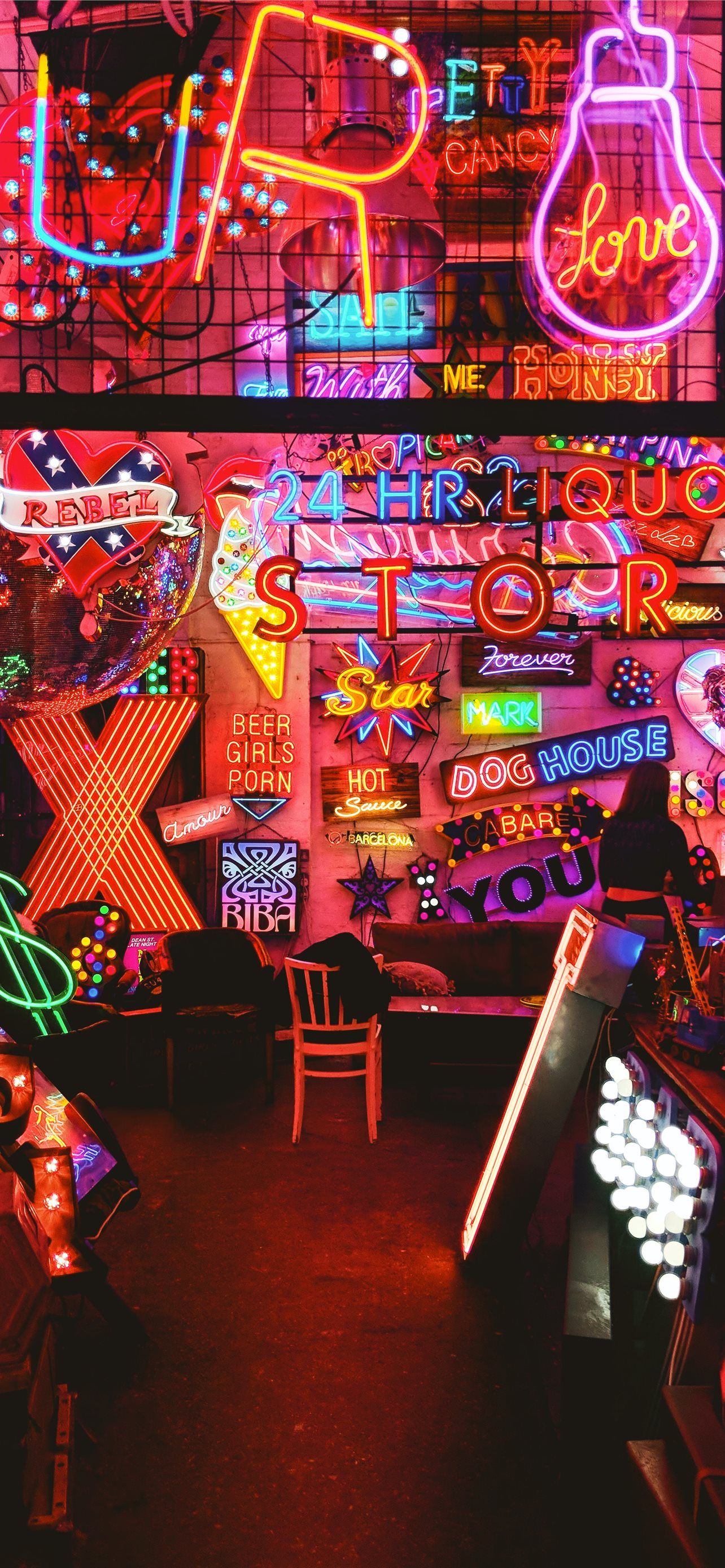 A room filled with a variety of different colored neon signs. - 