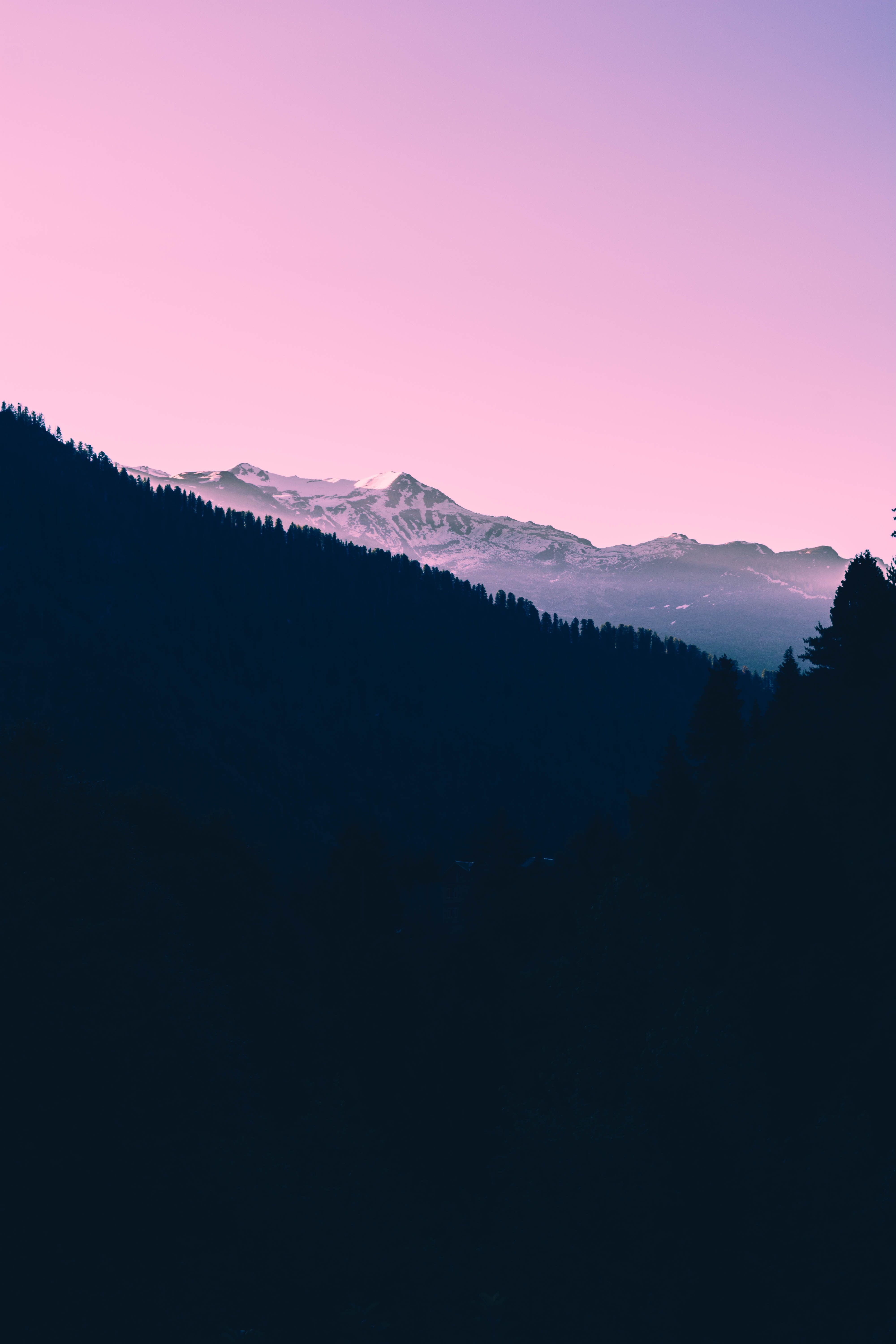 A pink and purple sunset over a mountain range - Twilight