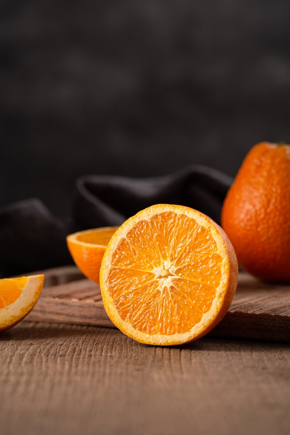 A sliced orange on a wooden table. - Pastel orange