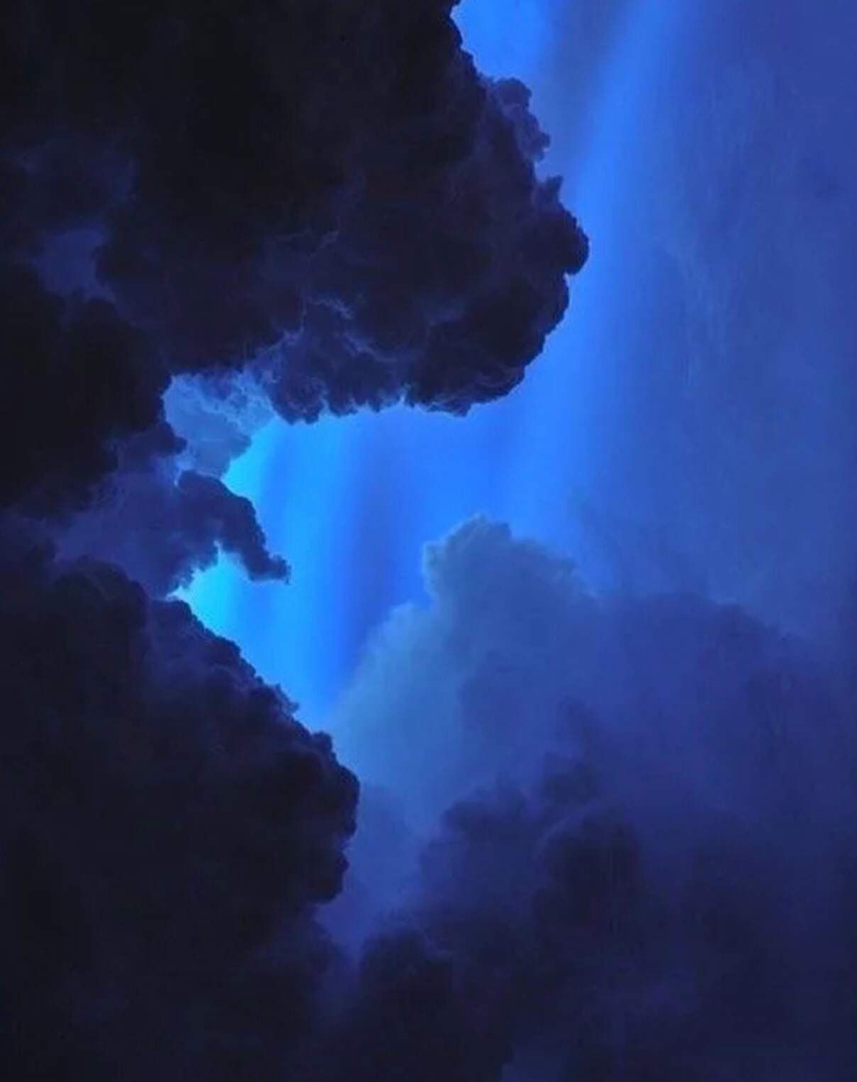 A dark cloud with blue light coming from it - Navy blue, indigo