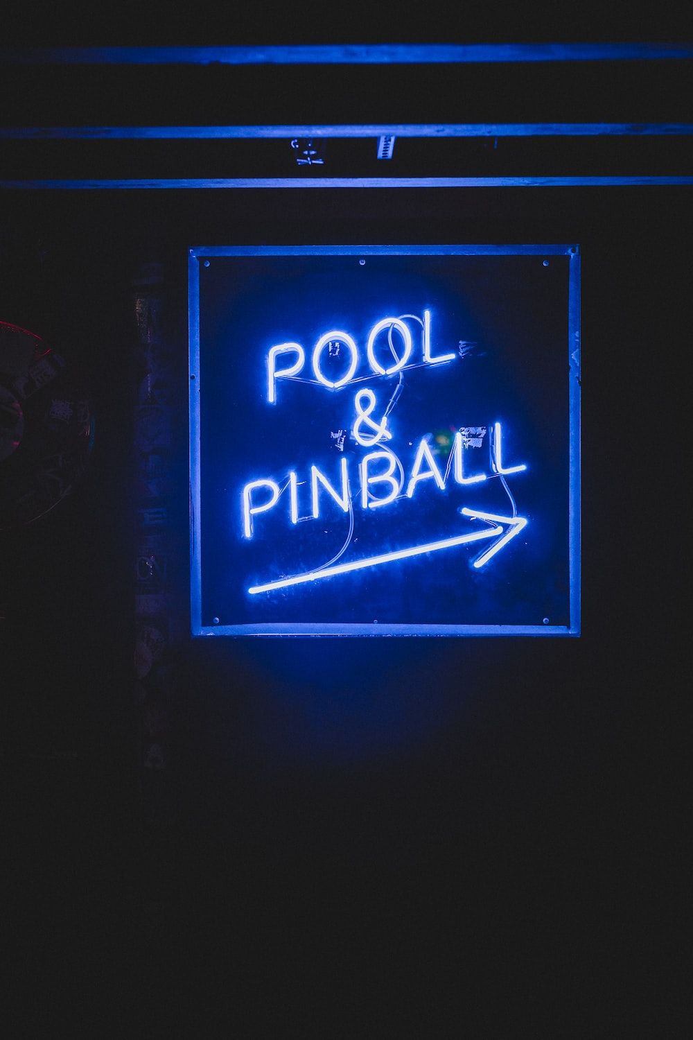 A neon sign that says pool and pinball - Navy blue