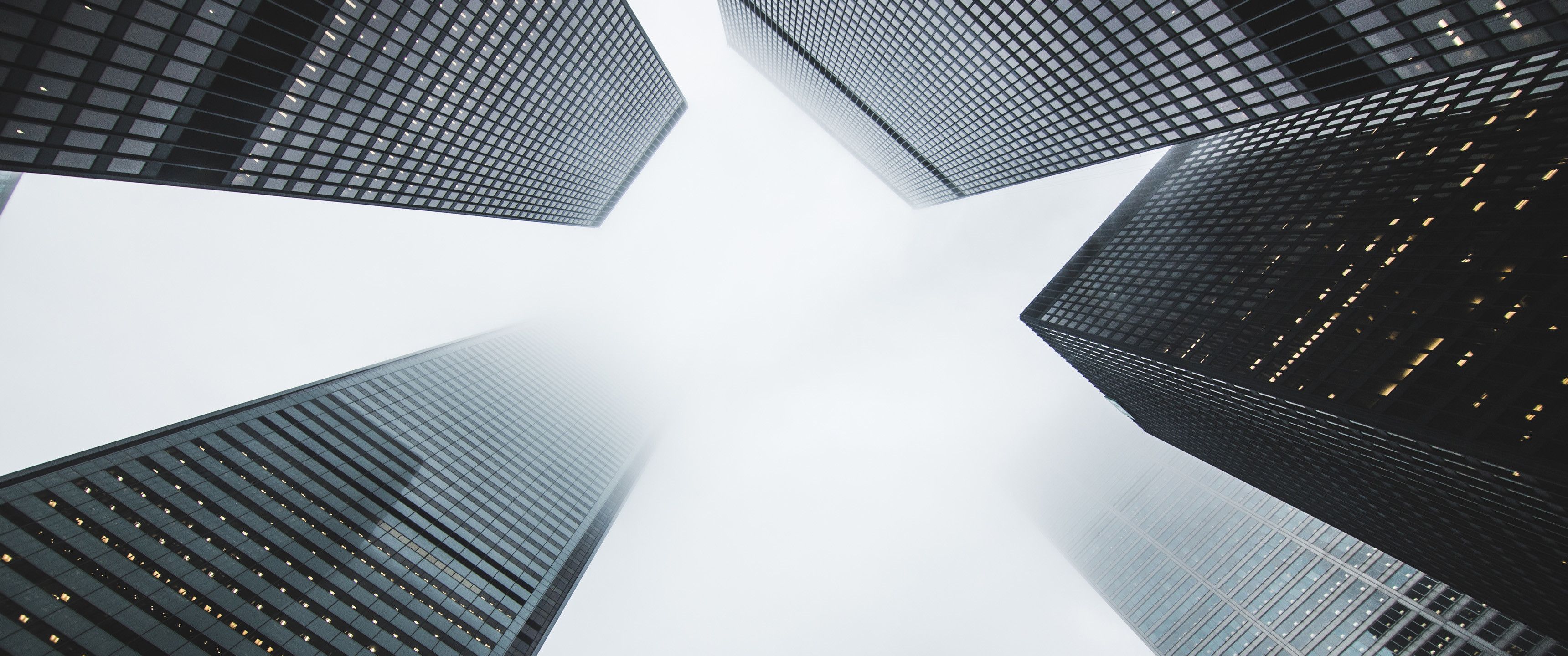 A view from the bottom of tall buildings - 3440x1440, sky, fog