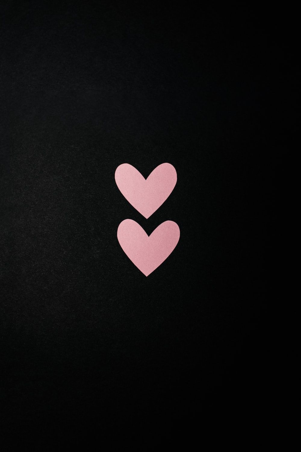 A black background with two pink hearts - Pink heart