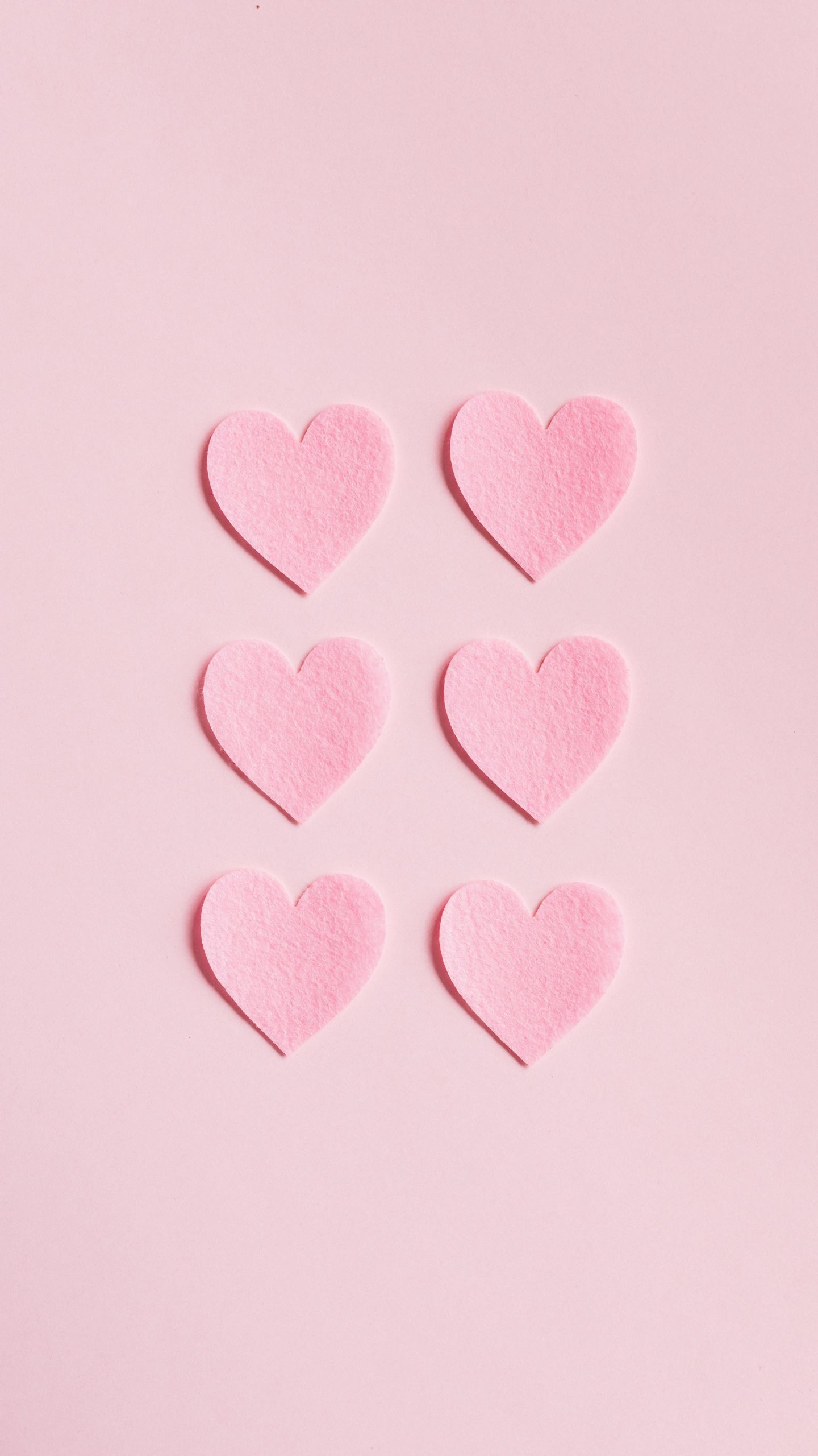 Four pink hearts are on a light colored background - Pink heart
