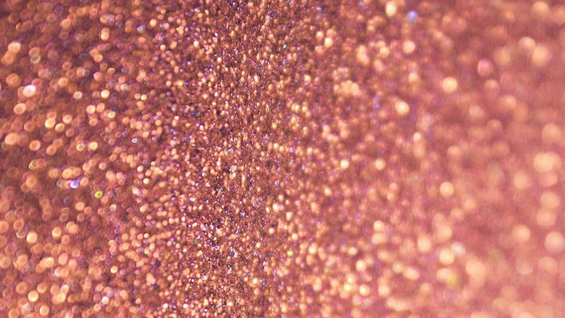 A close up of a glittery pink background - Rose gold, gold