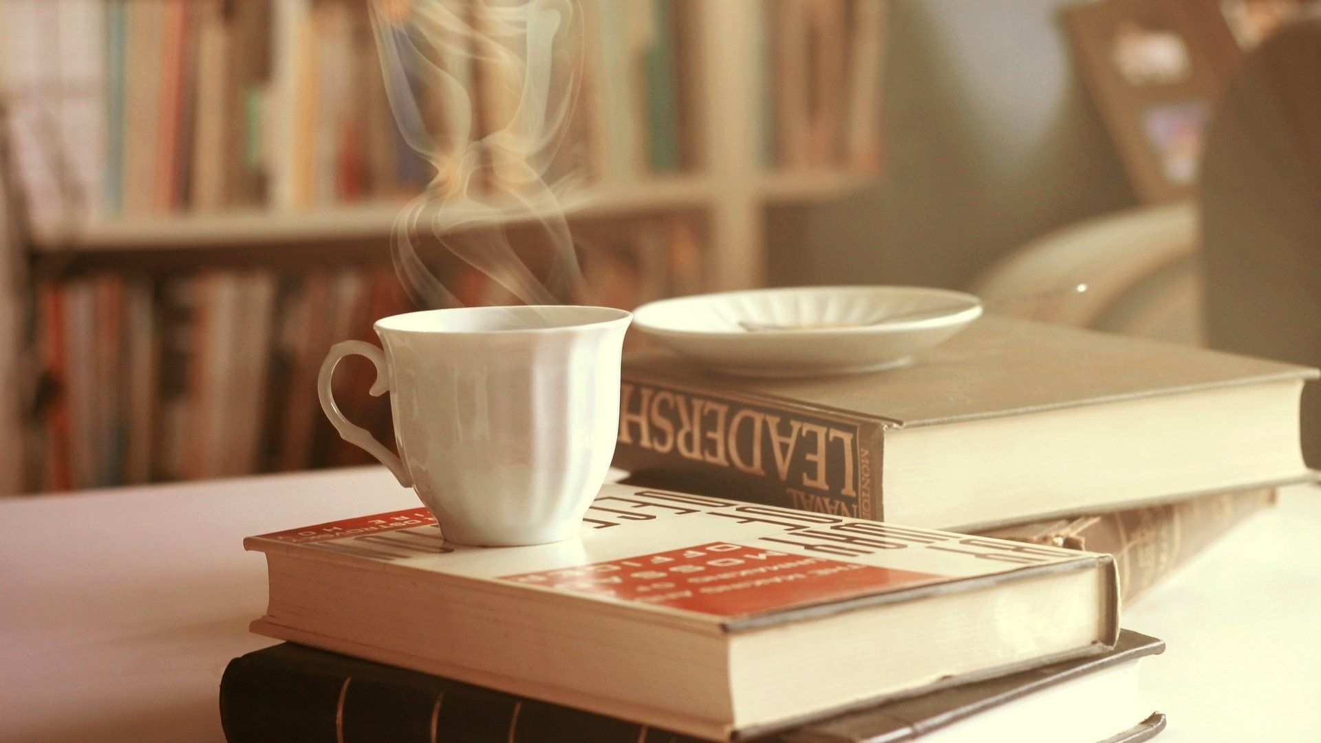 A cup of coffee sitting on top books - Books, coffee