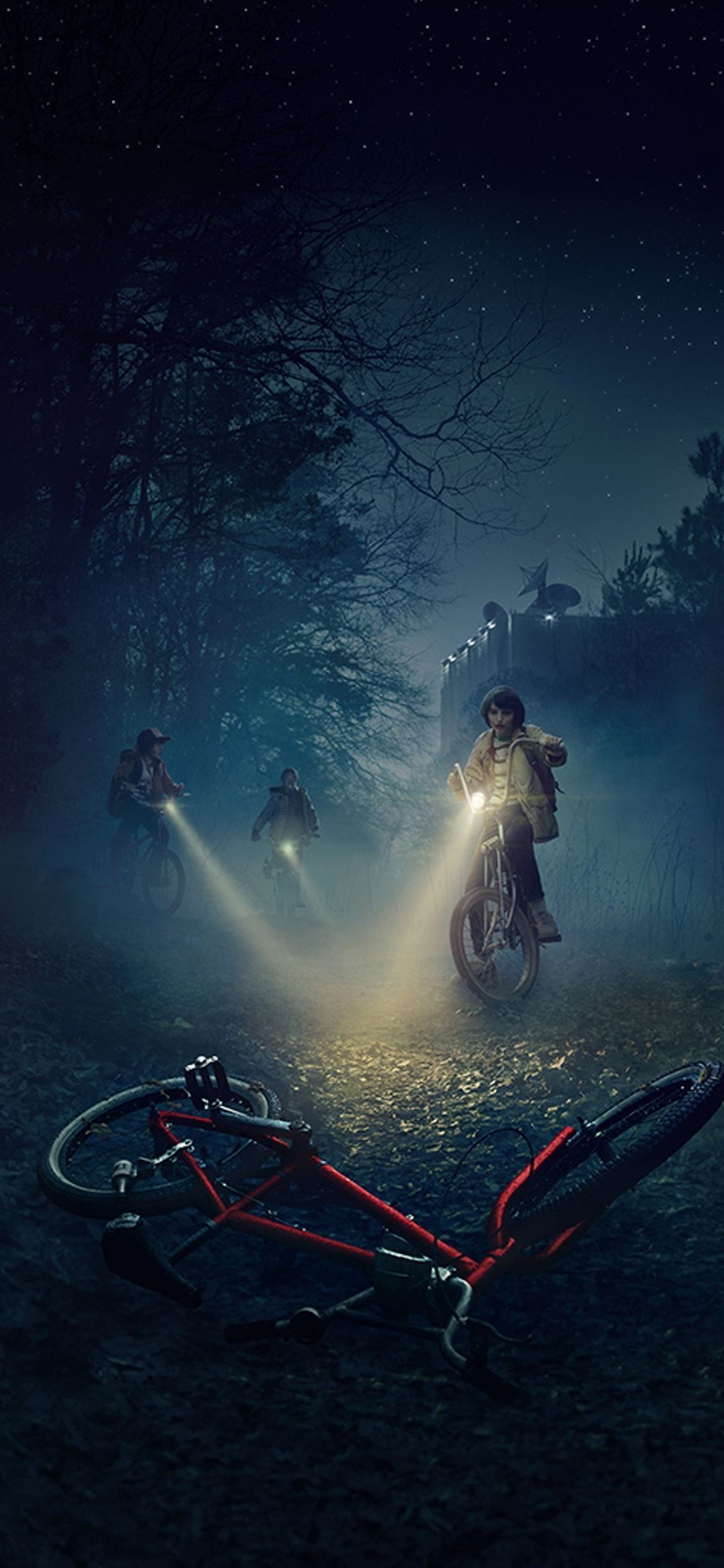 A group of people riding bikes in the dark - Stranger Things