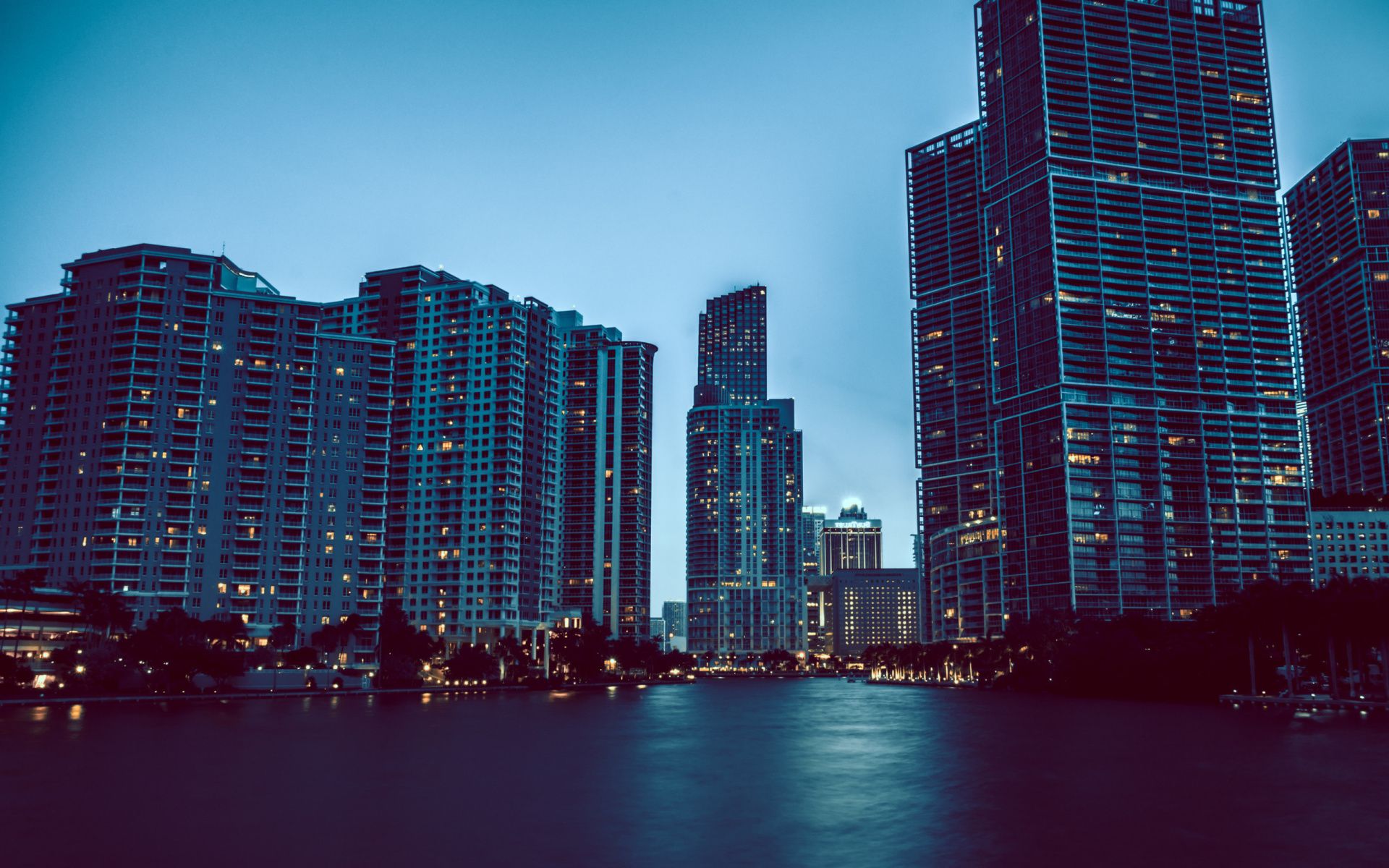 A city skyline with tall buildings and water - Miami