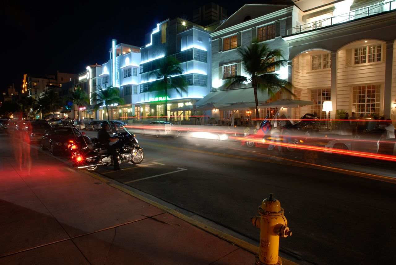 A street with cars and buildings at night - Miami