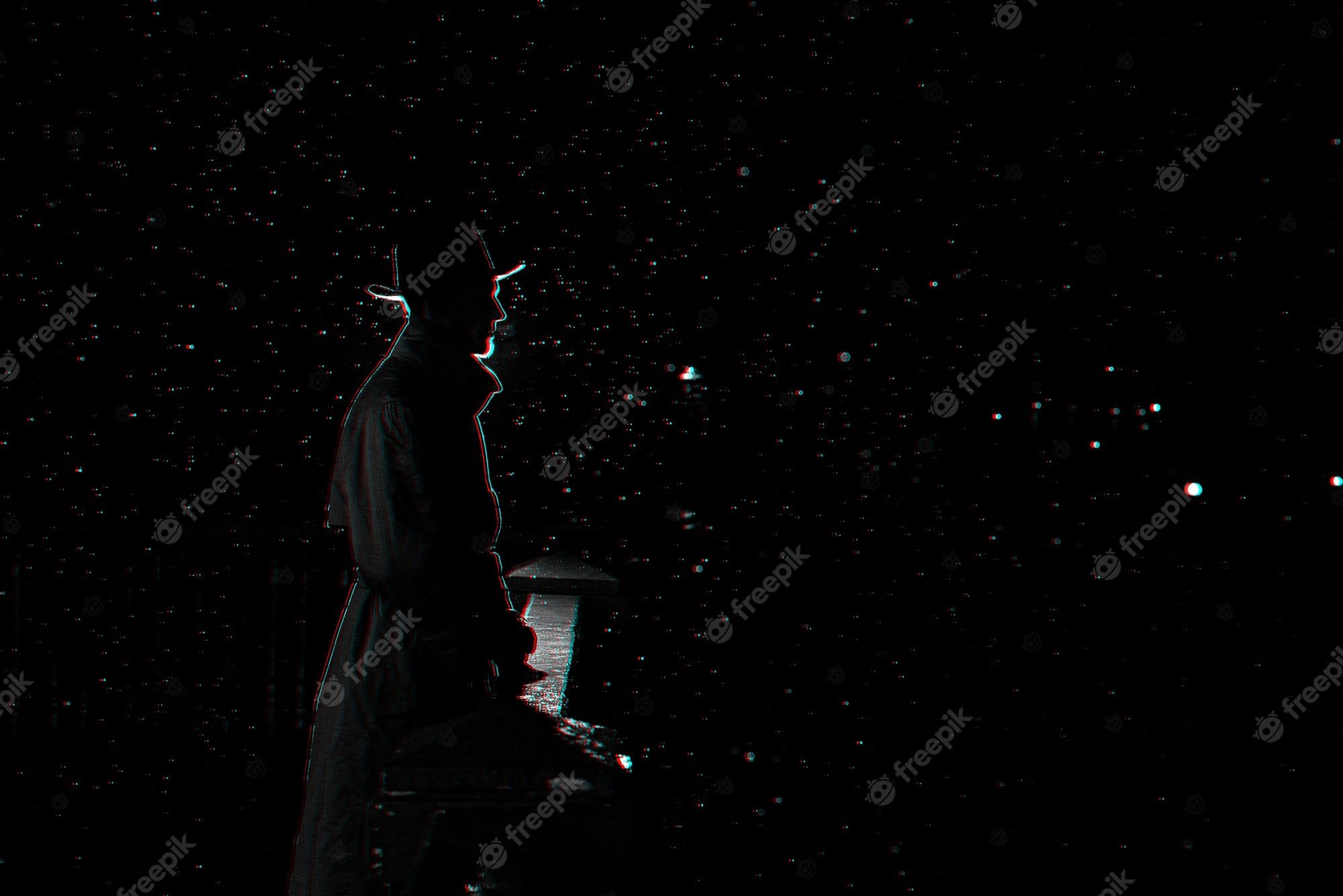 Premium Photo. Dark silhouette of a man in a hat at night in the rain in the city. black and white with 3D glitch virtual reality effect