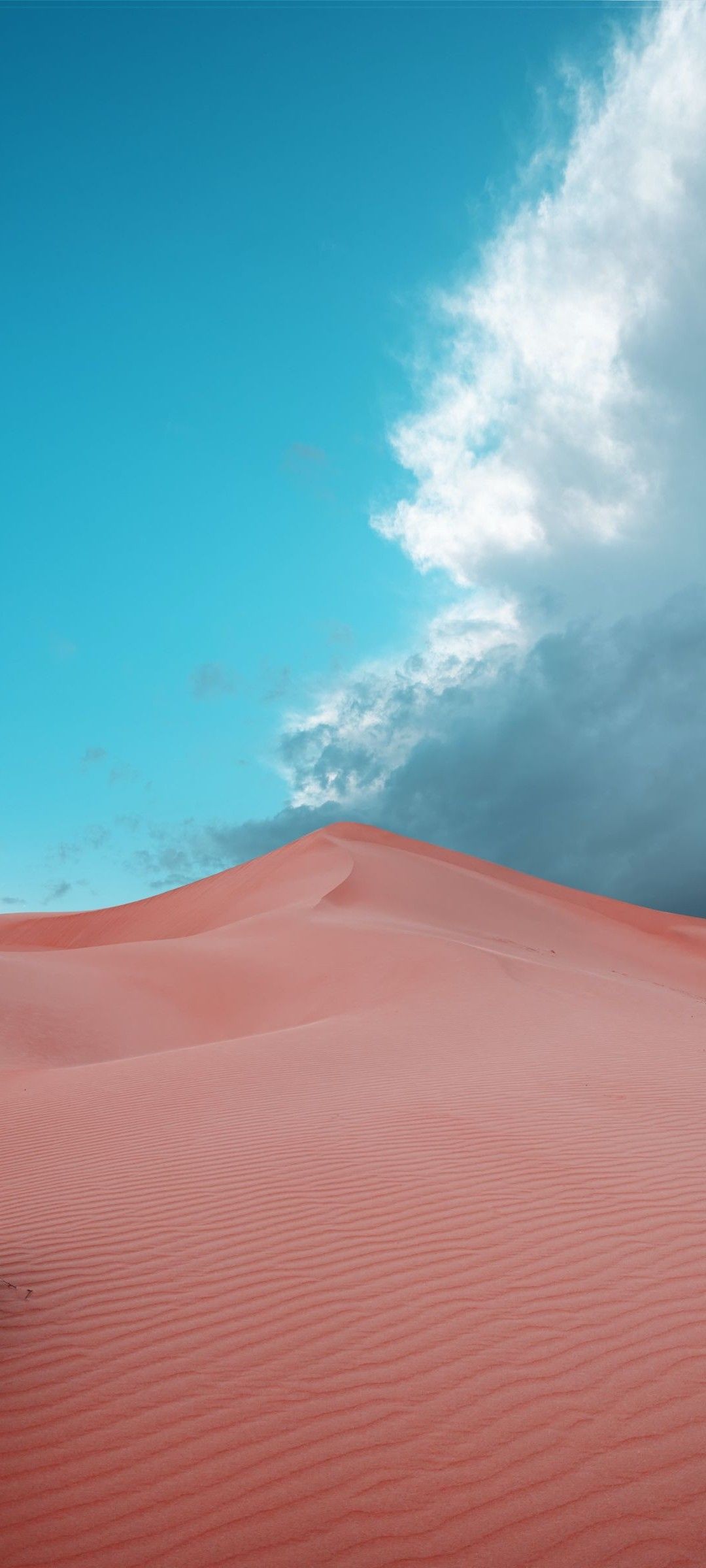 A red car is parked in the sand - Warm