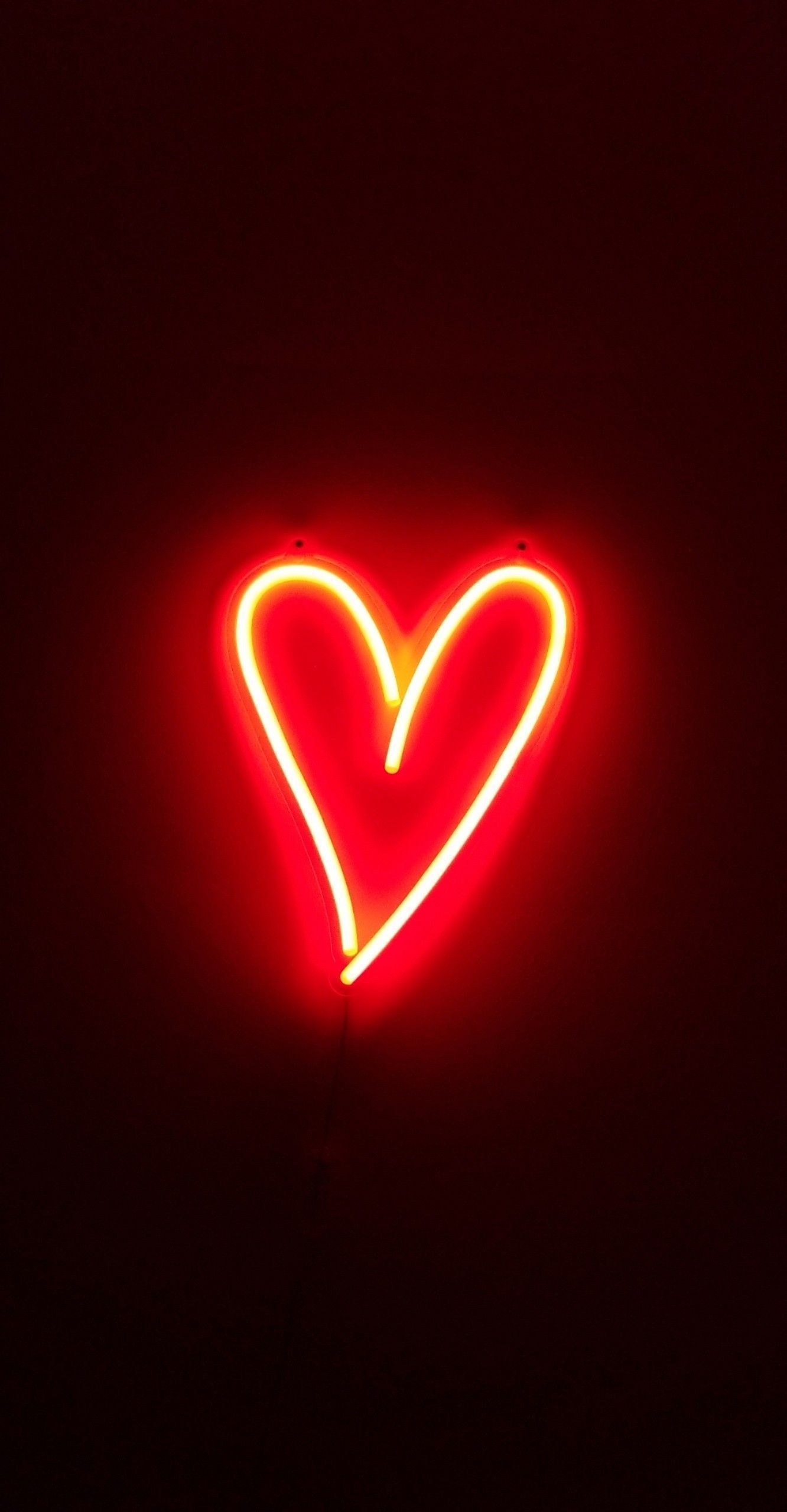 A red neon sign in the shape of a heart. - Light red, neon red