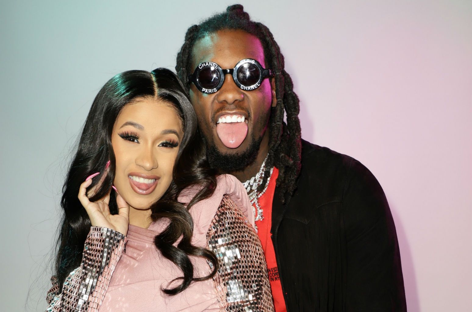 A man and woman posing for the camera - Cardi B