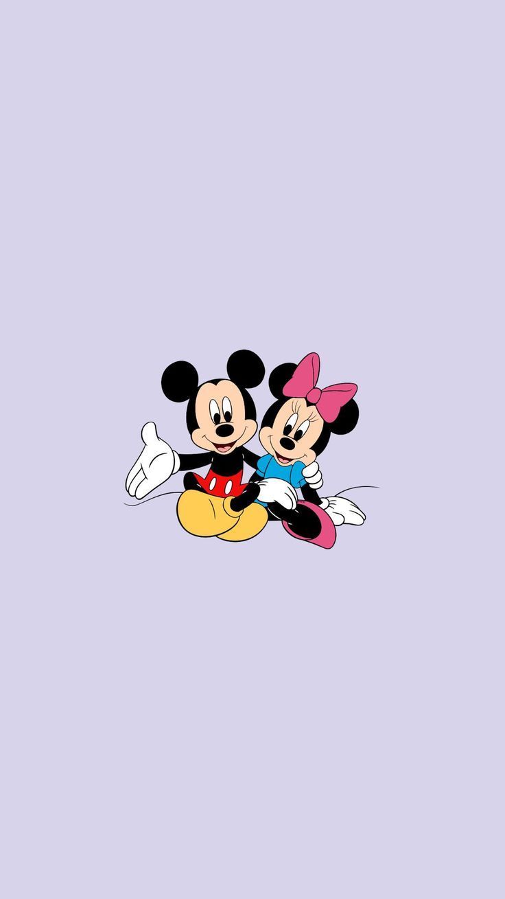 Mickey Mouse and Minnie Mouse sitting on a purple background - Minnie Mouse
