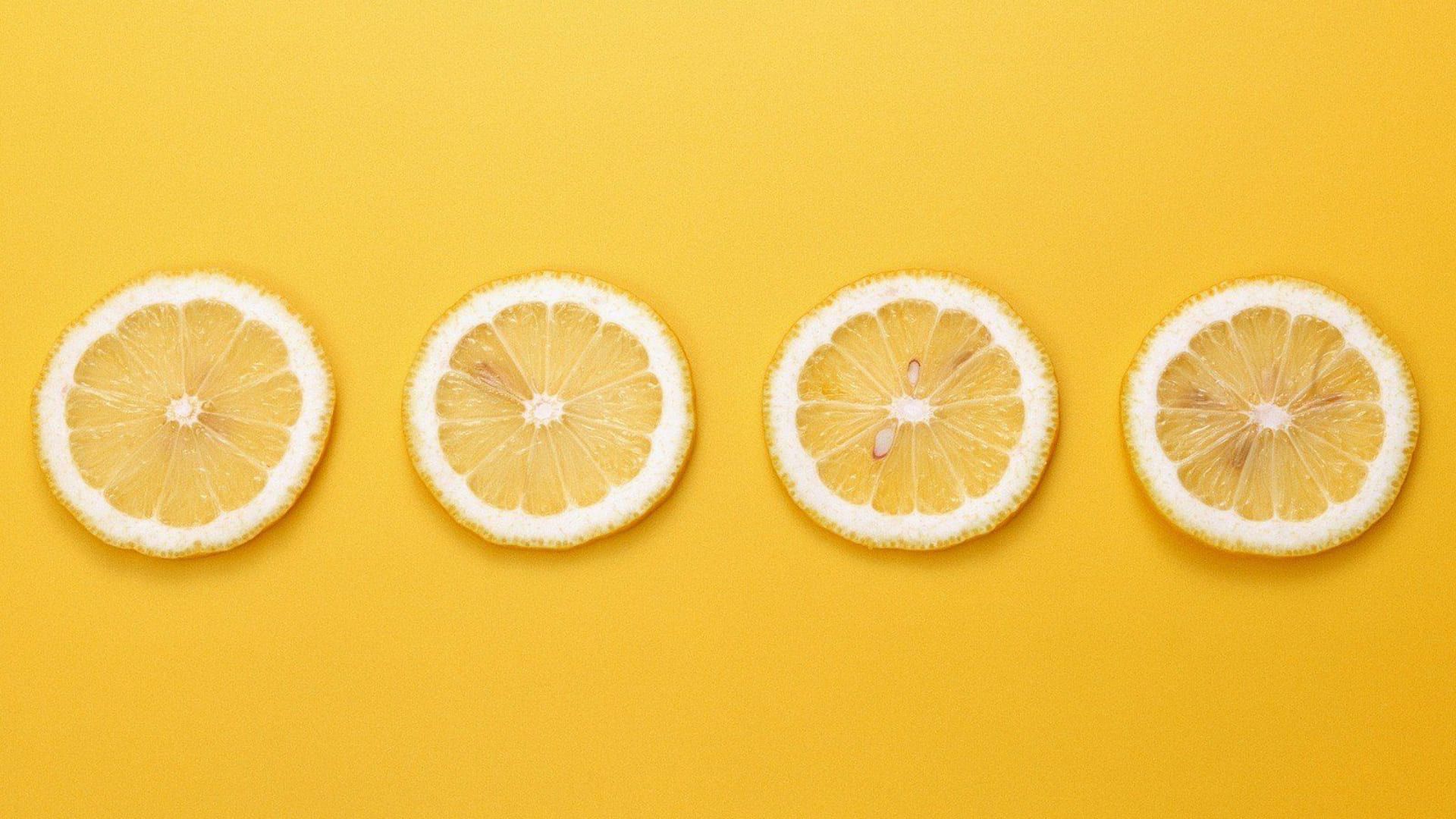 Four slices of lemon on a yellow background - Yellow
