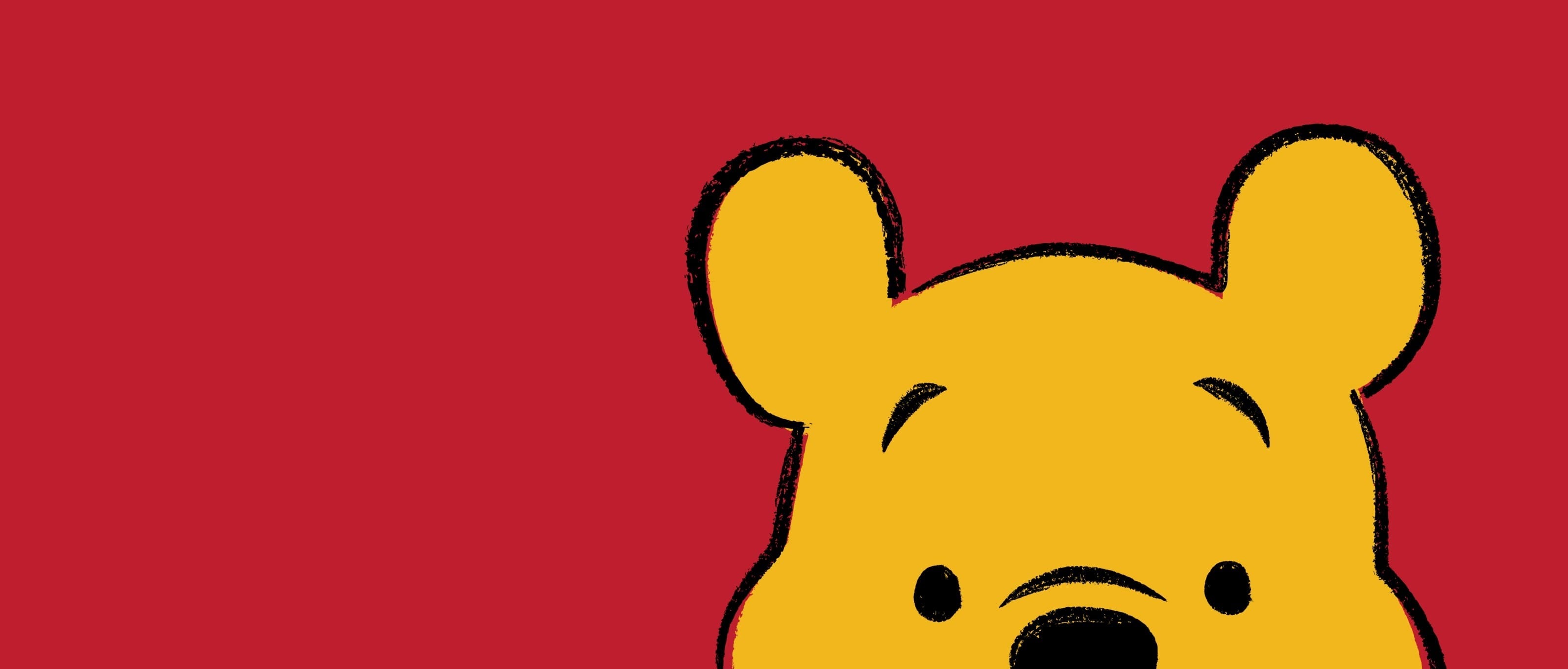 A cartoon image of a yellow bear with a red background - Winnie the Pooh