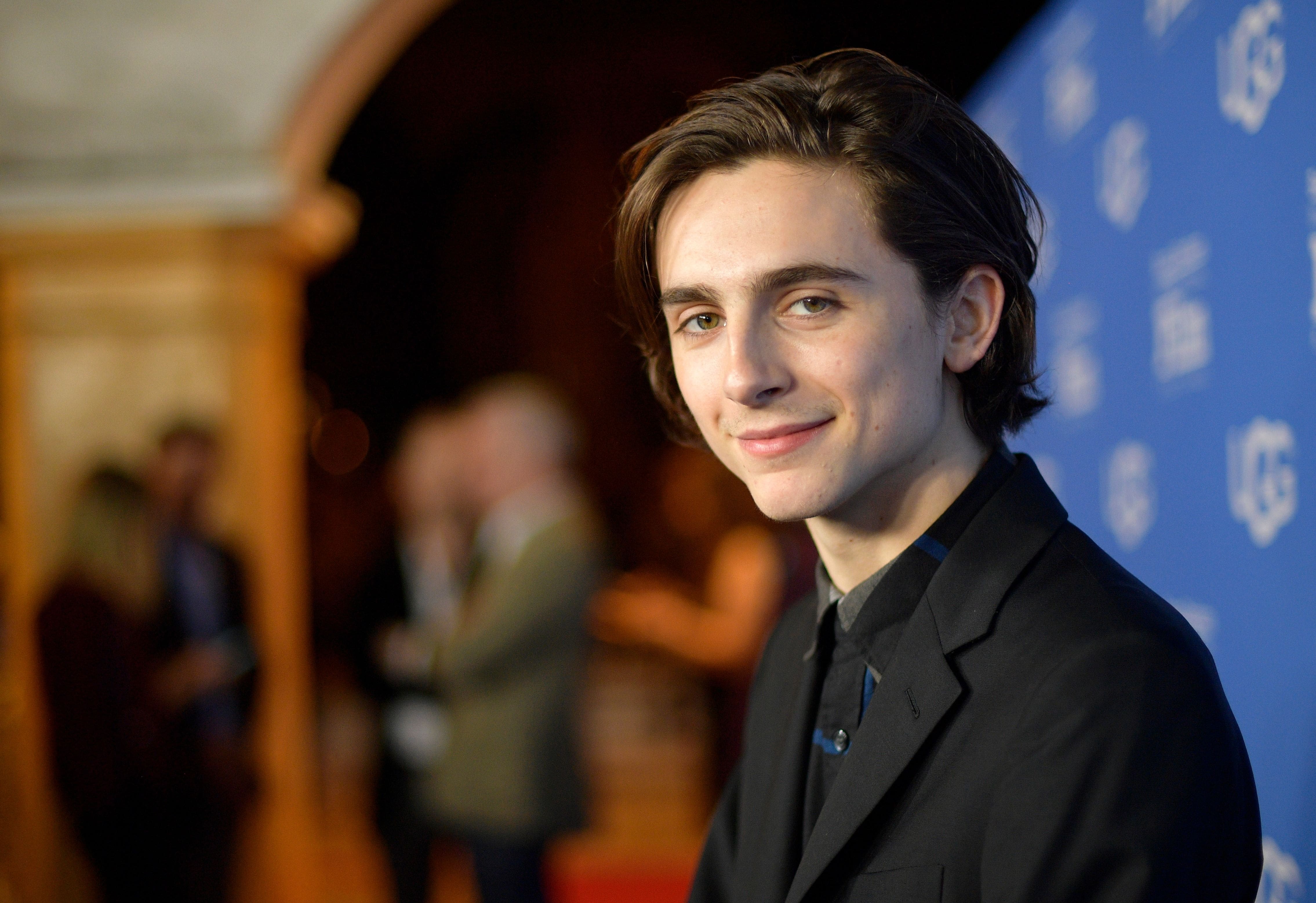 A young man in black suit and tie - Timothee Chalamet