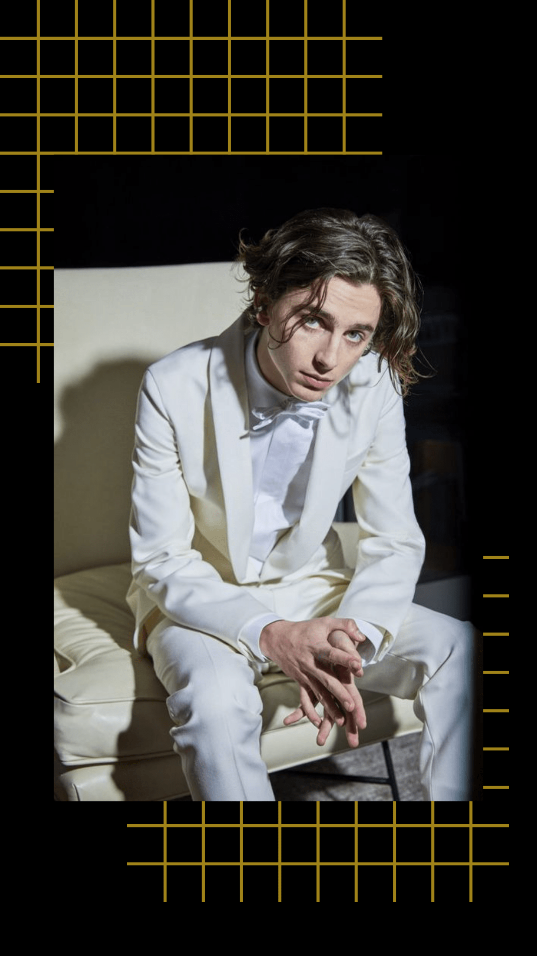 Timothee Chalamet in a white suit sitting on a couch - Timothee Chalamet