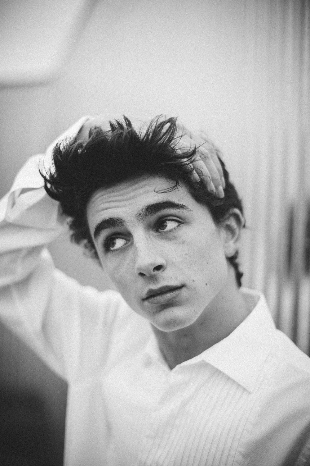 A man in white shirt and tie is looking at the camera - Timothee Chalamet