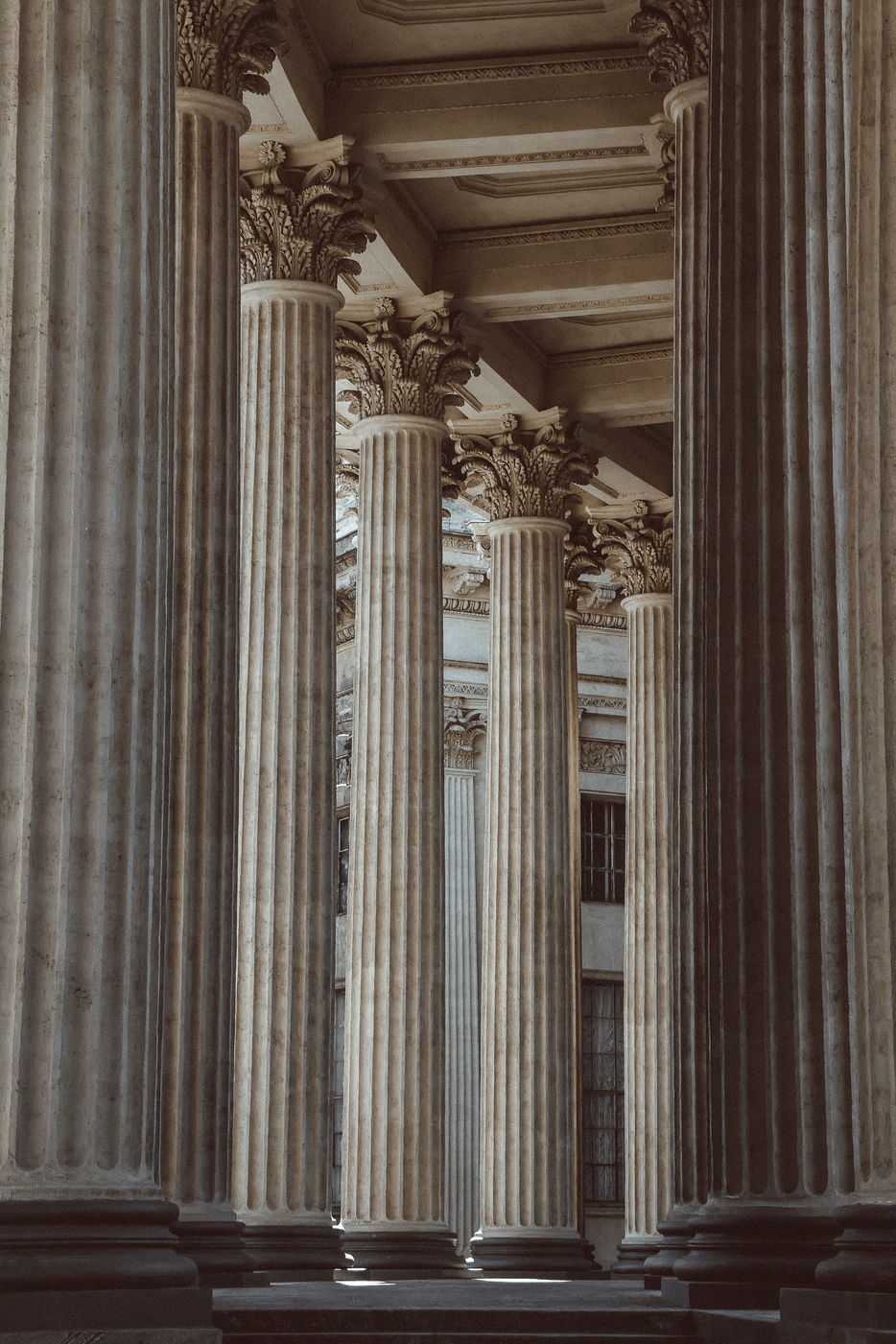 A row of columns in a building. - Light academia