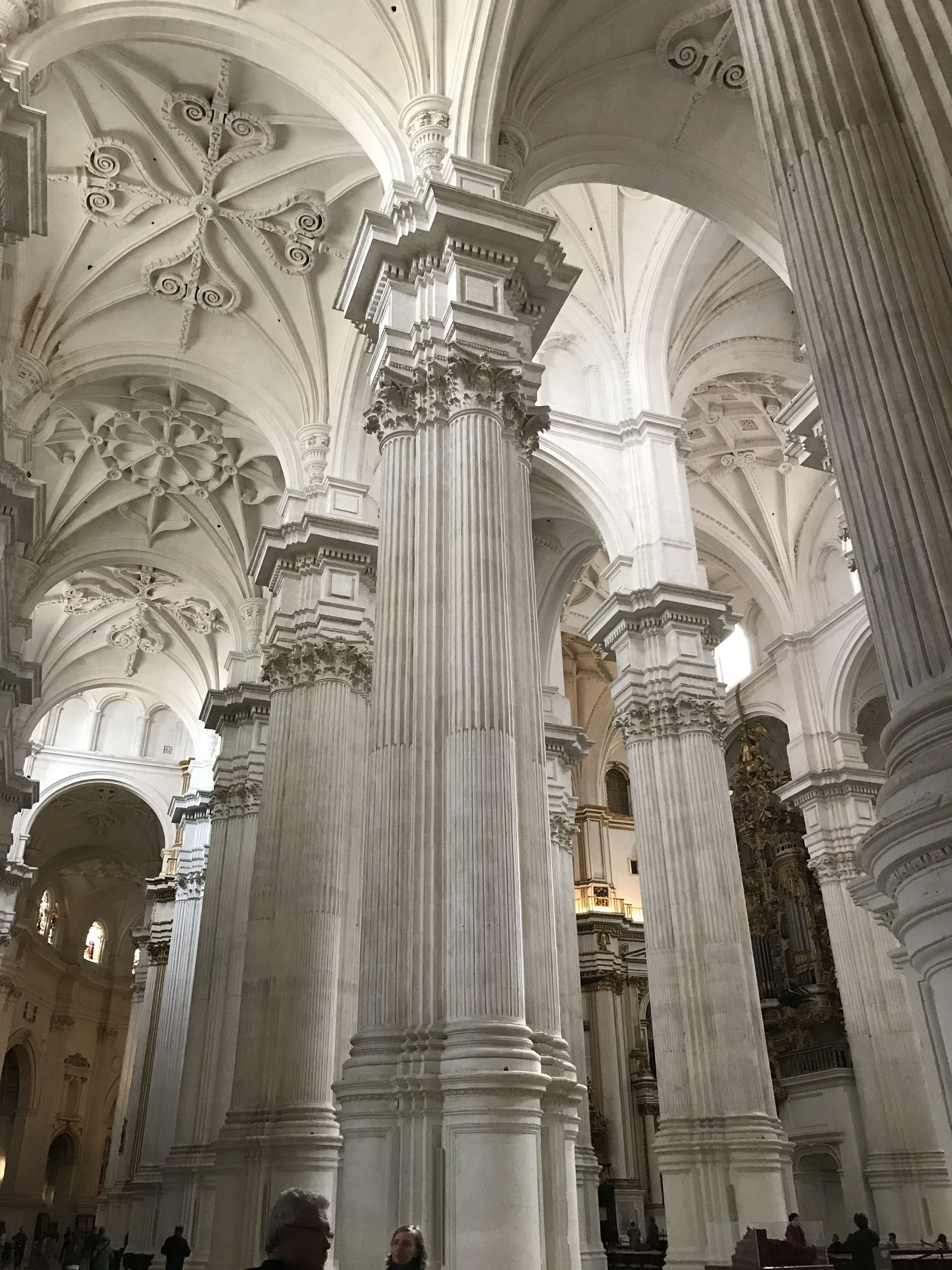A large white column in the middle of a cathedral. - Light academia