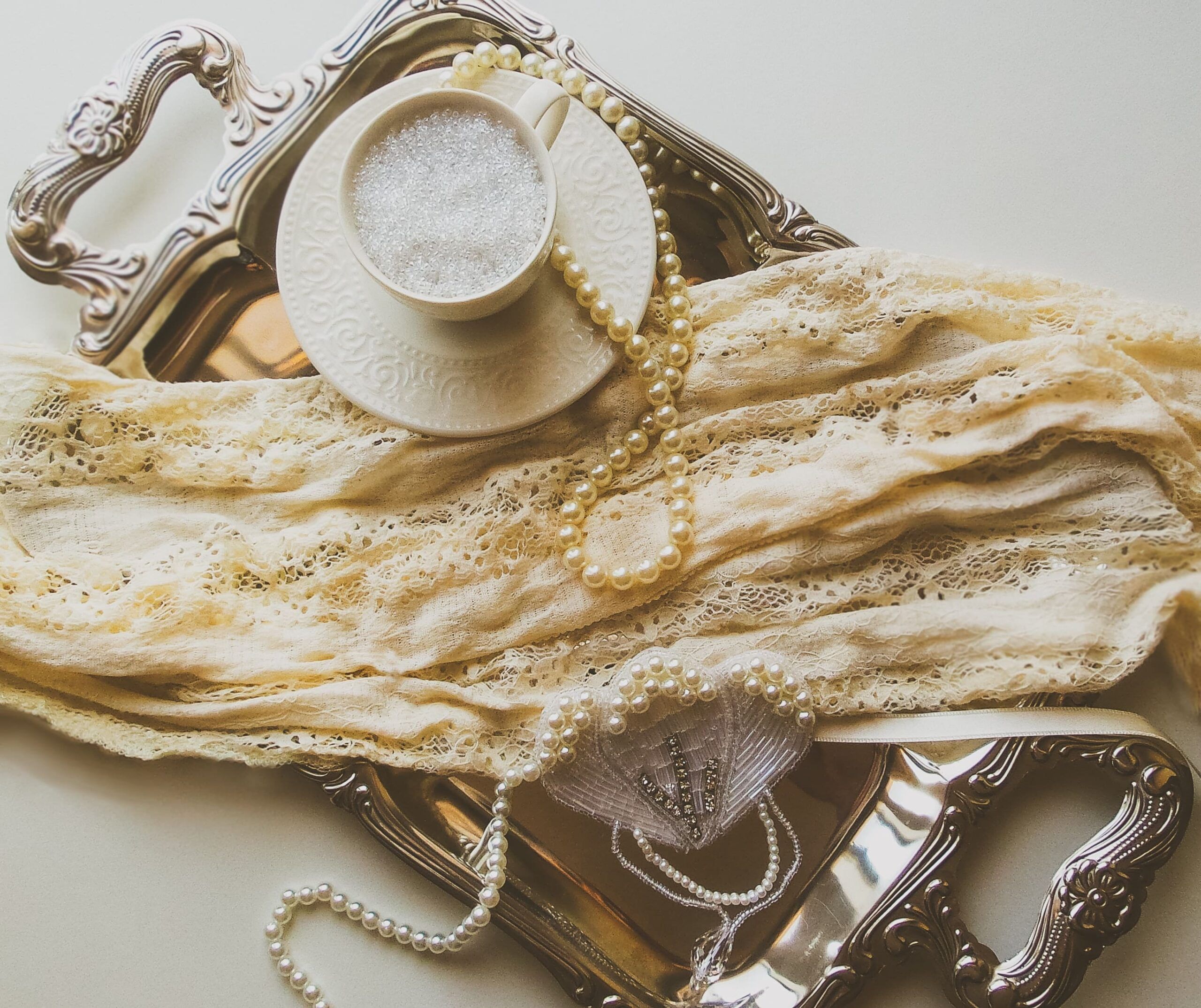 A tray with pearls and tea on it - Light academia, flat lay
