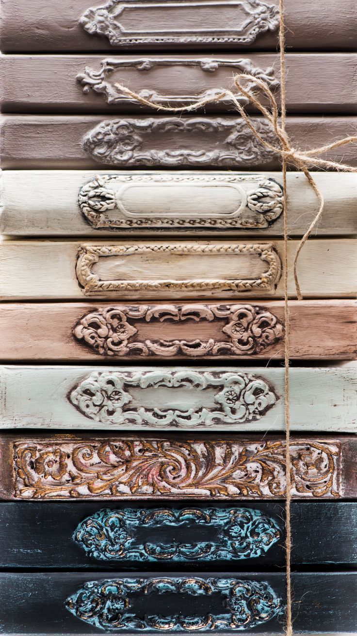 A collection of antique, ornate drawer pulls in a variety of colors and designs. - Light academia