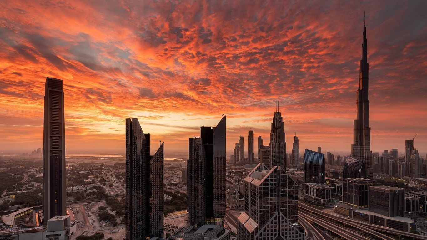 The skyline of Dubai, with the Burj Khalifa, at sunset. - 1366x768, Dubai
