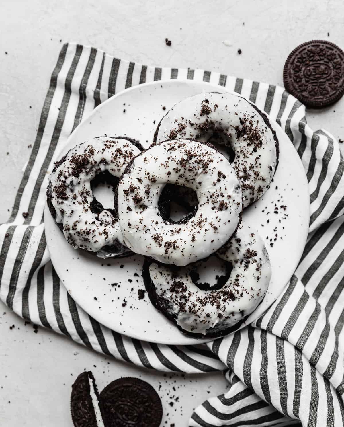 Four oreo donuts on a plate with a striped napkin - Oreo