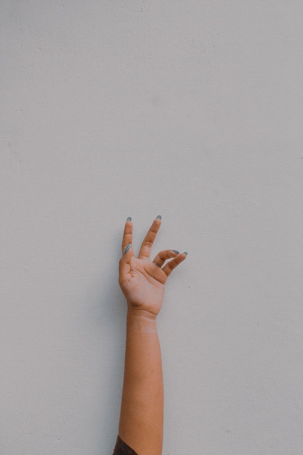 A person reaching out to touch the wall - 