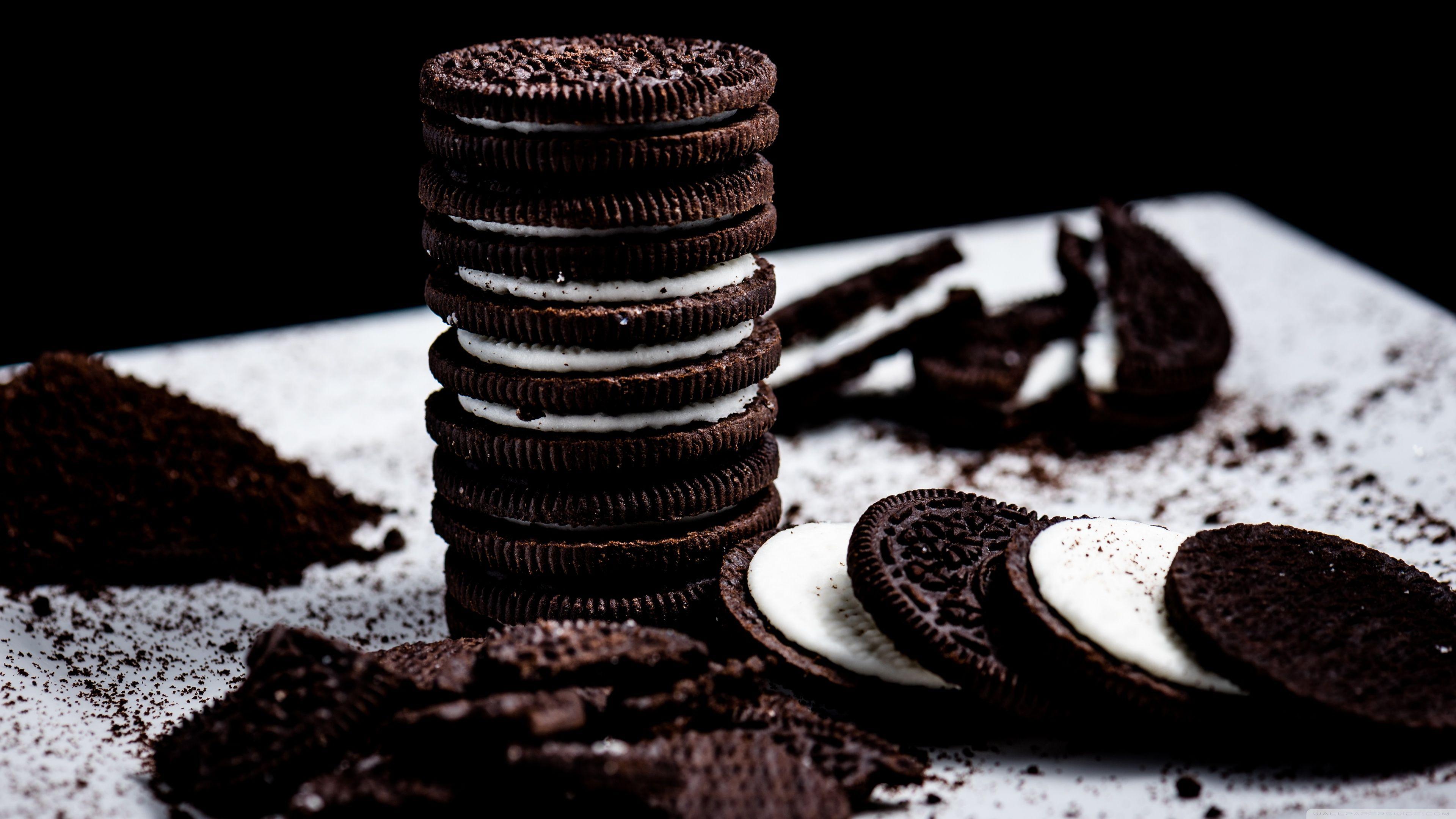 A stack of chocolate sandwich cookies with white cream in the middle - Oreo