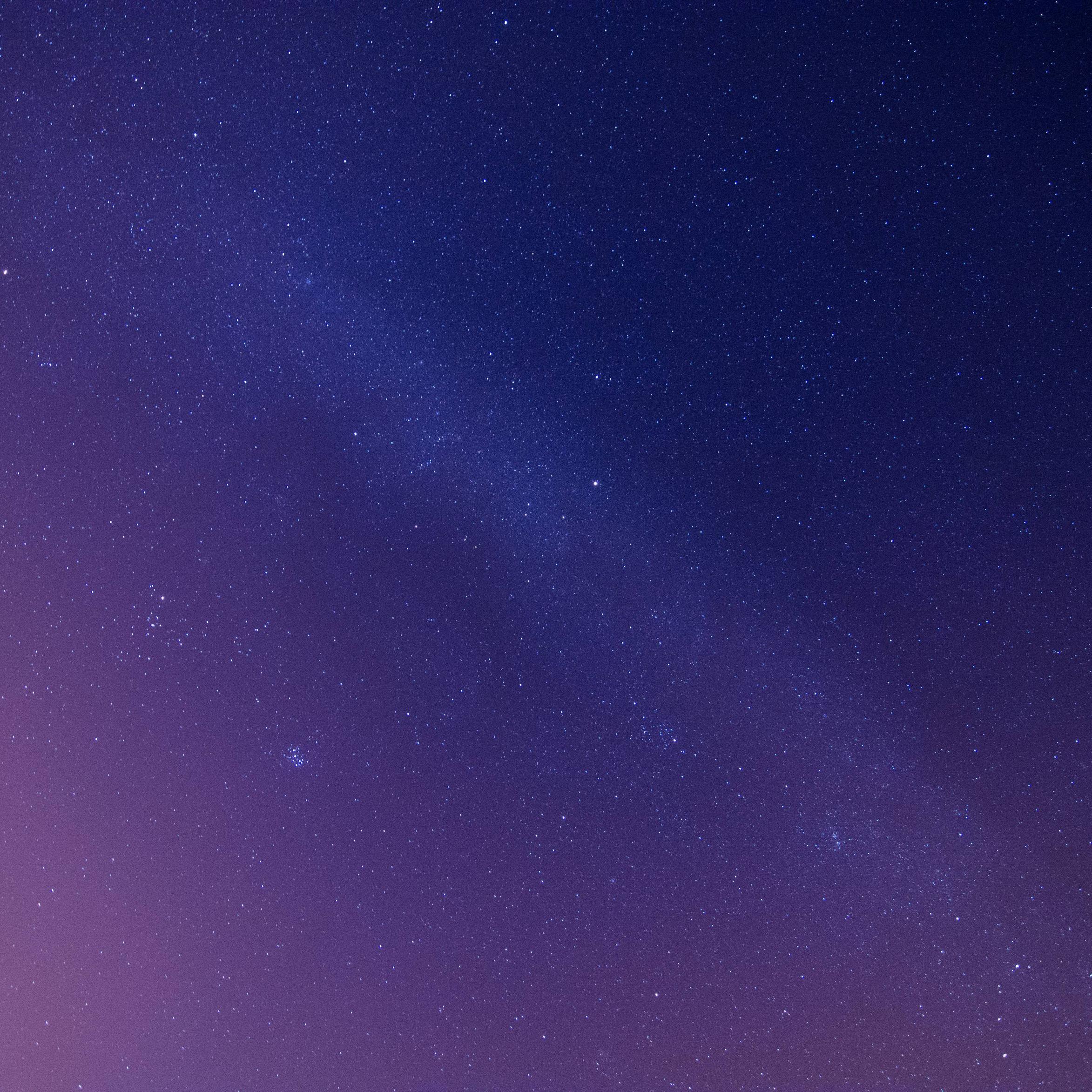 A starry night sky with a purple and blue gradient. - Constellation