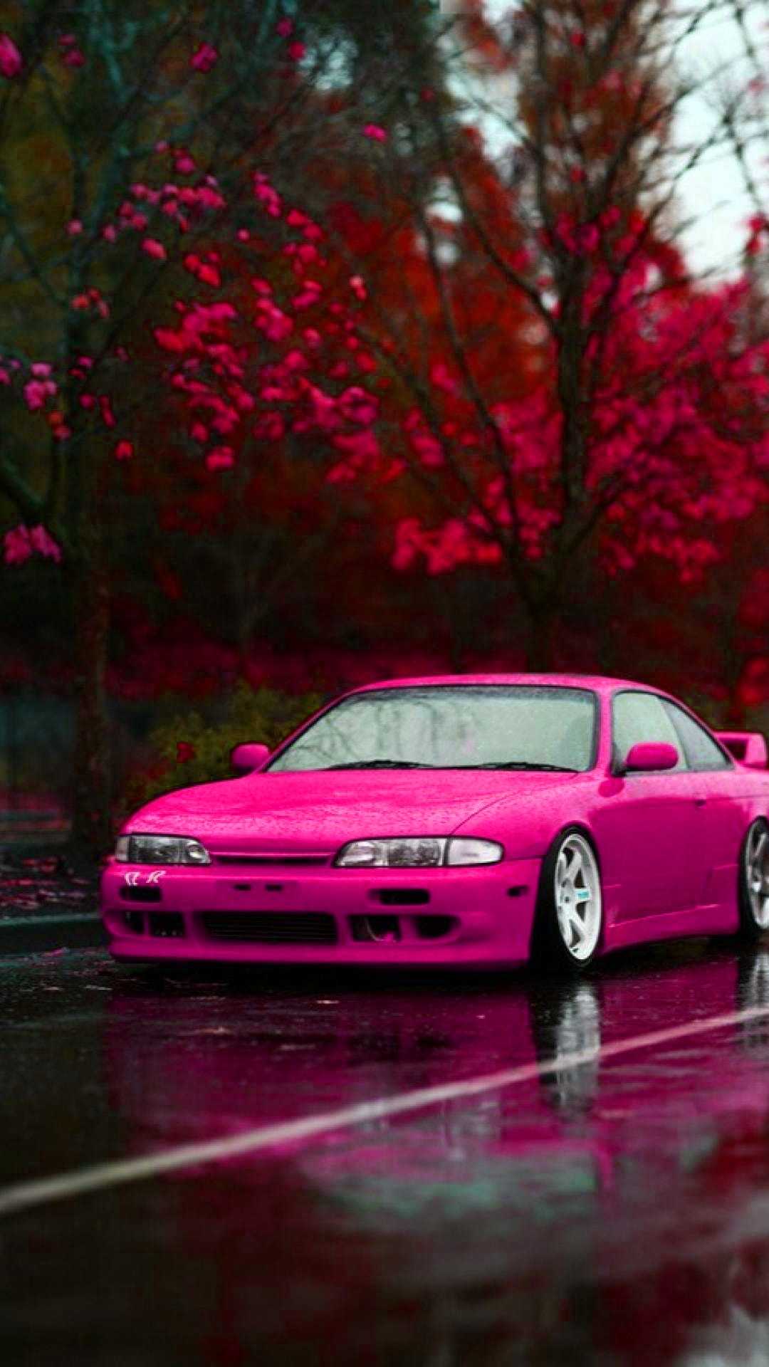 A pink car parked on the street - JDM