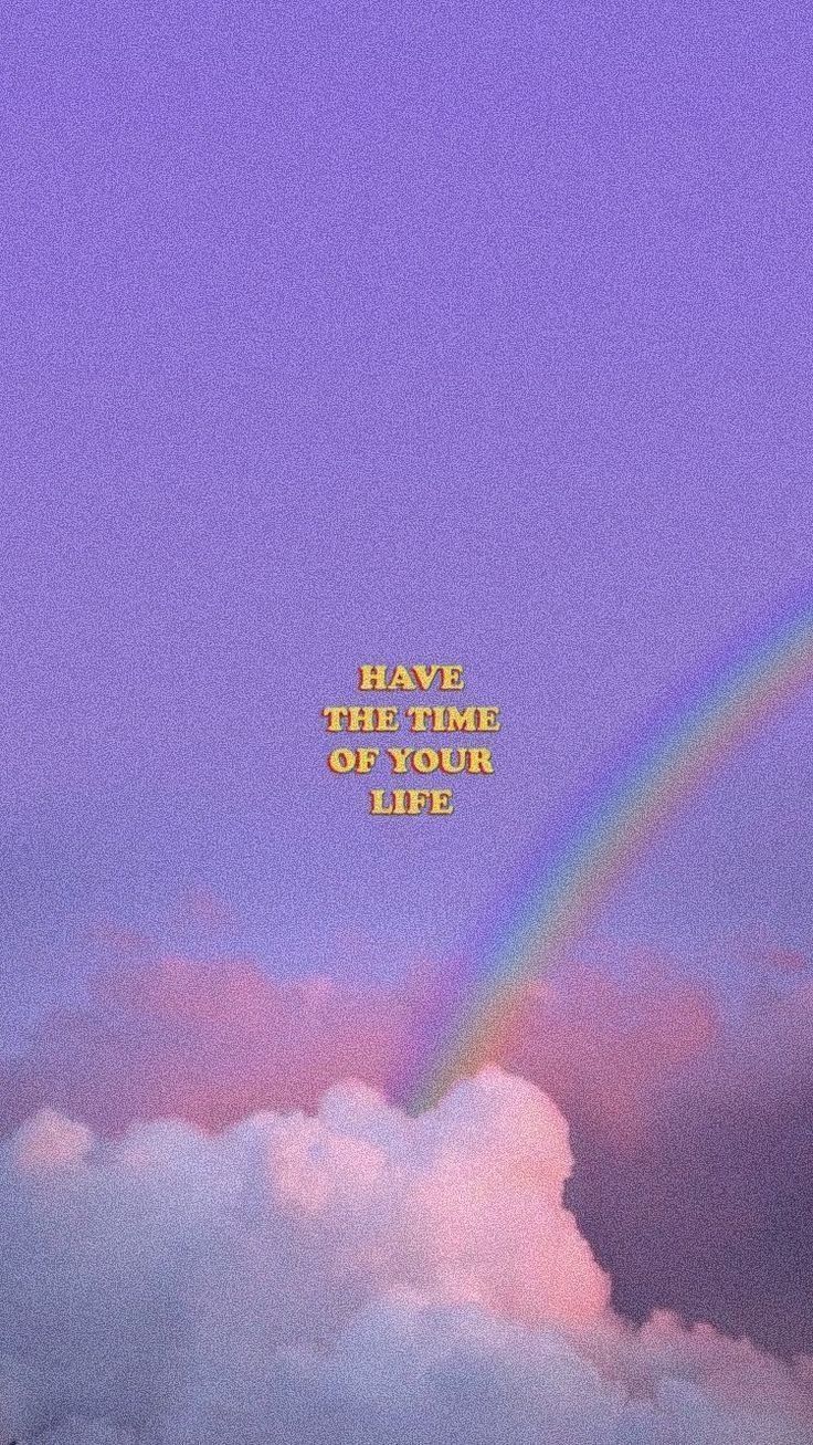 Aesthetic wallpaper of a rainbow in a purple sky with the words 